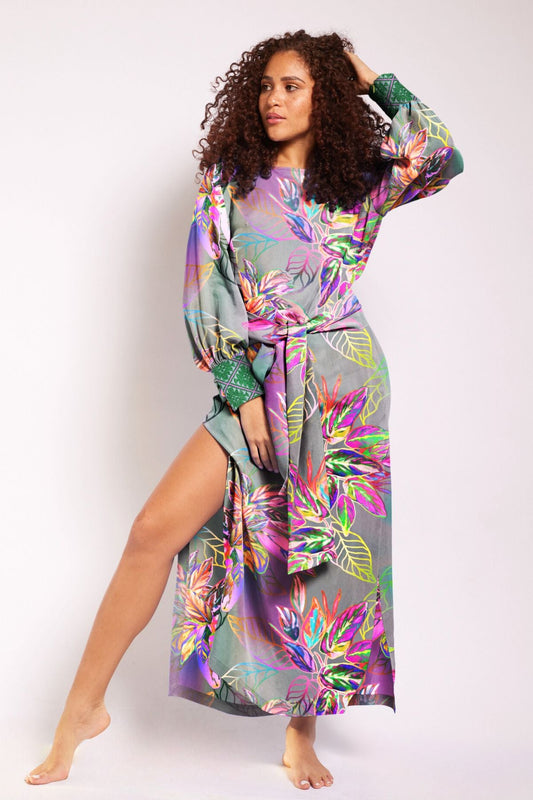 woman wearing all over tropical printed kaftan duster with embroidered cuffs made from recycled materials