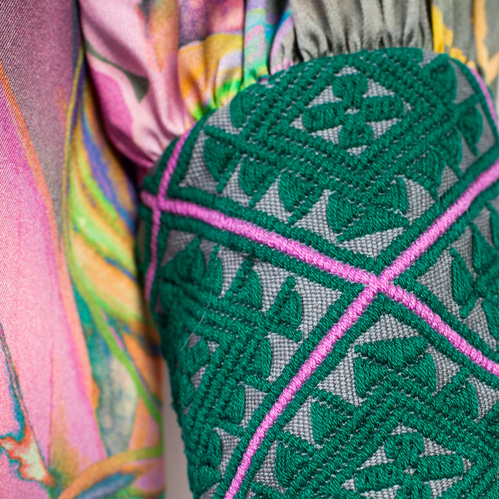 close up of all over tropical printed kaftan duster with embroidered cuffs made from recycled materials