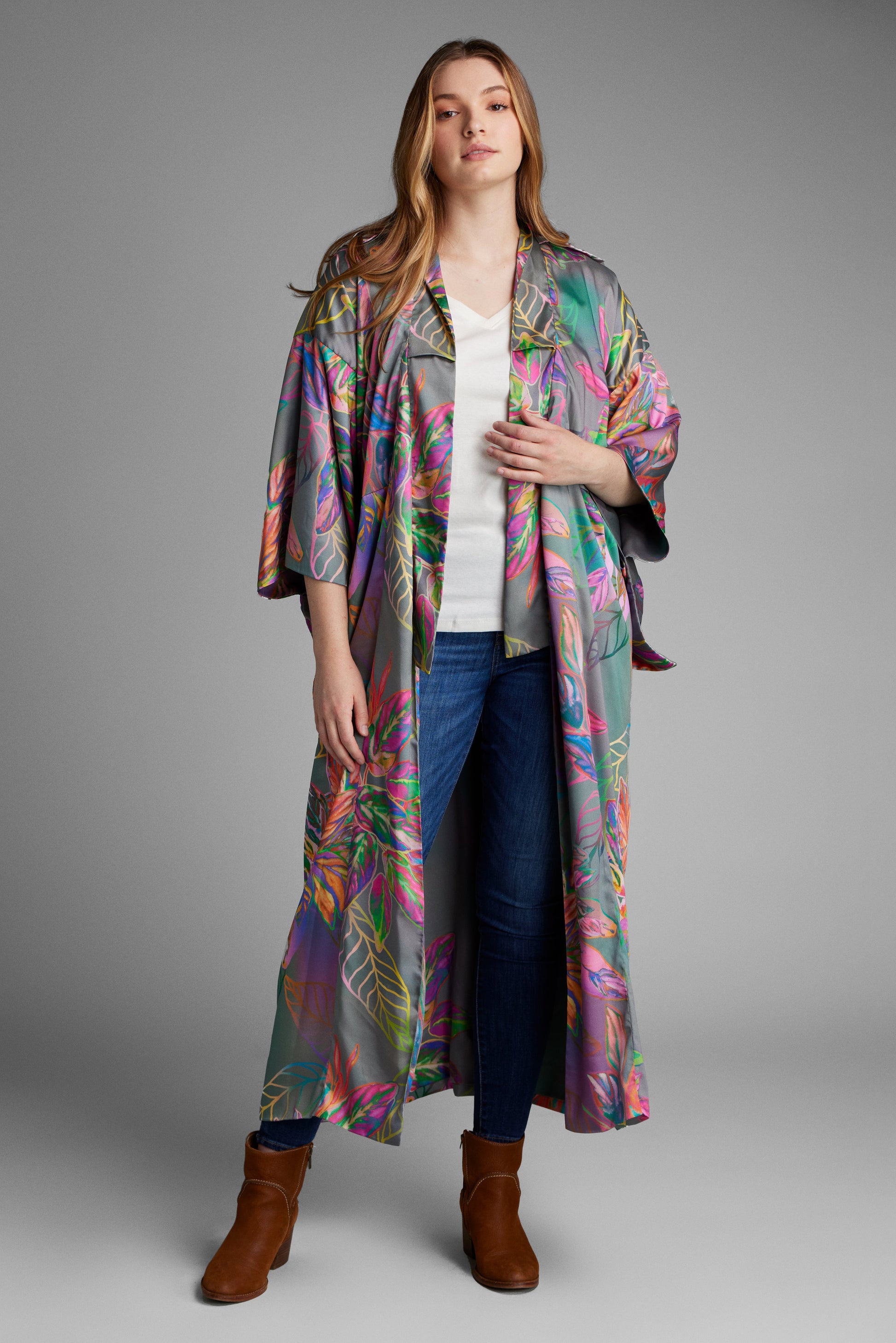 Woman standing wearing an all over tropical printed kimono duster made from recycled materials 4