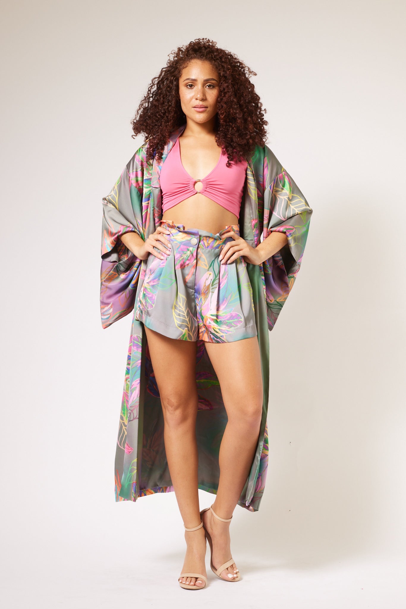 Front profile of woman modelling tropical printed tulips shorts and kimono duster made from recycled materials 2