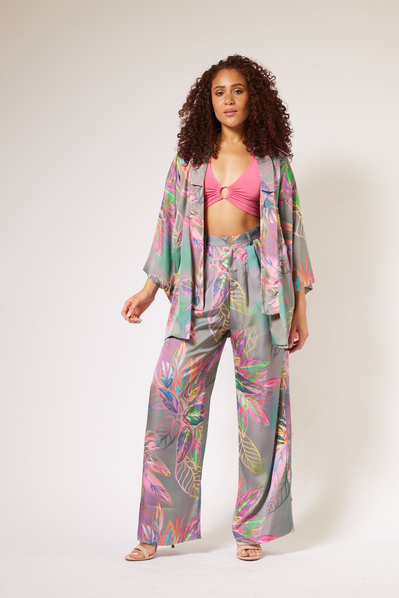 woman modelling all over multicolored tropical print kimono duster and matching yacht slacks made with recycled textiles