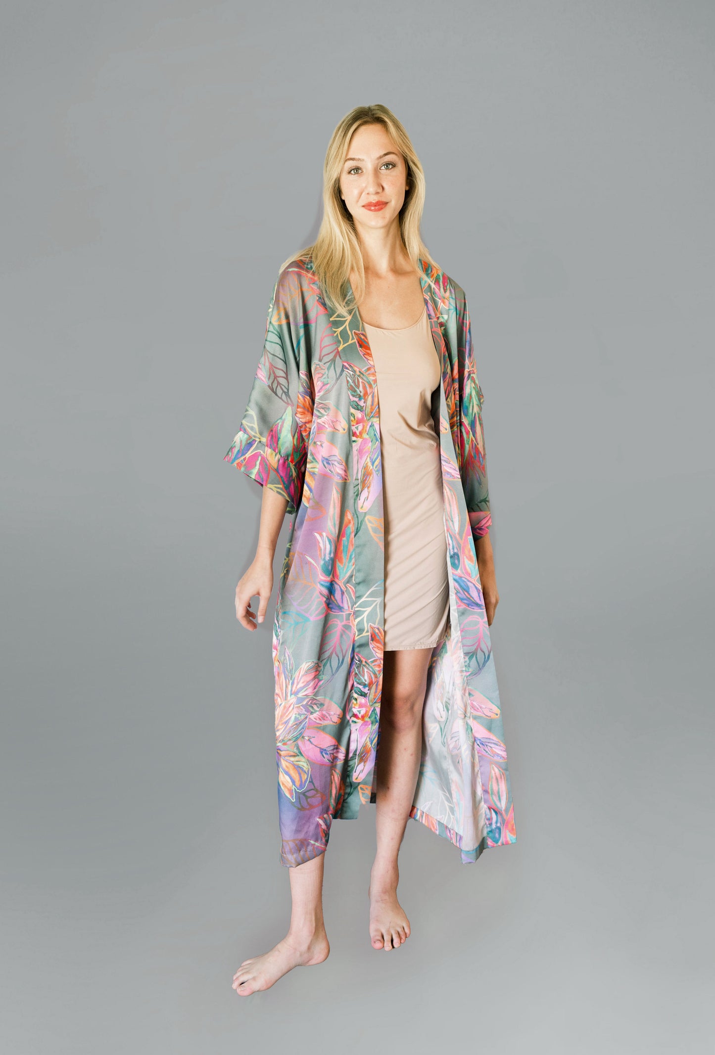 Woman wearing kimono robe in Carmen front profile view robe open overtop a nude slip dress