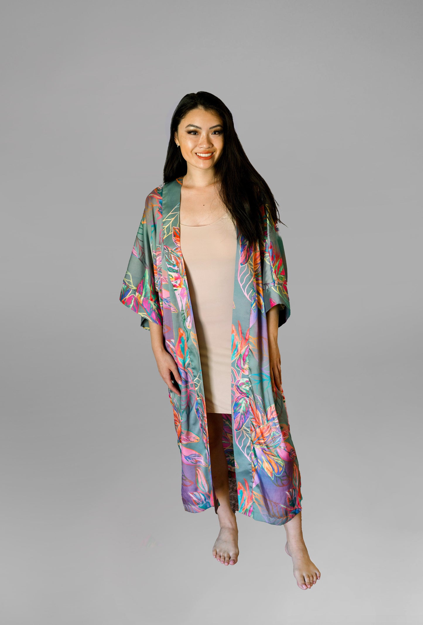 Woman wearing kimono robe in Carmen front profile view robe open overtop a nude slip dress