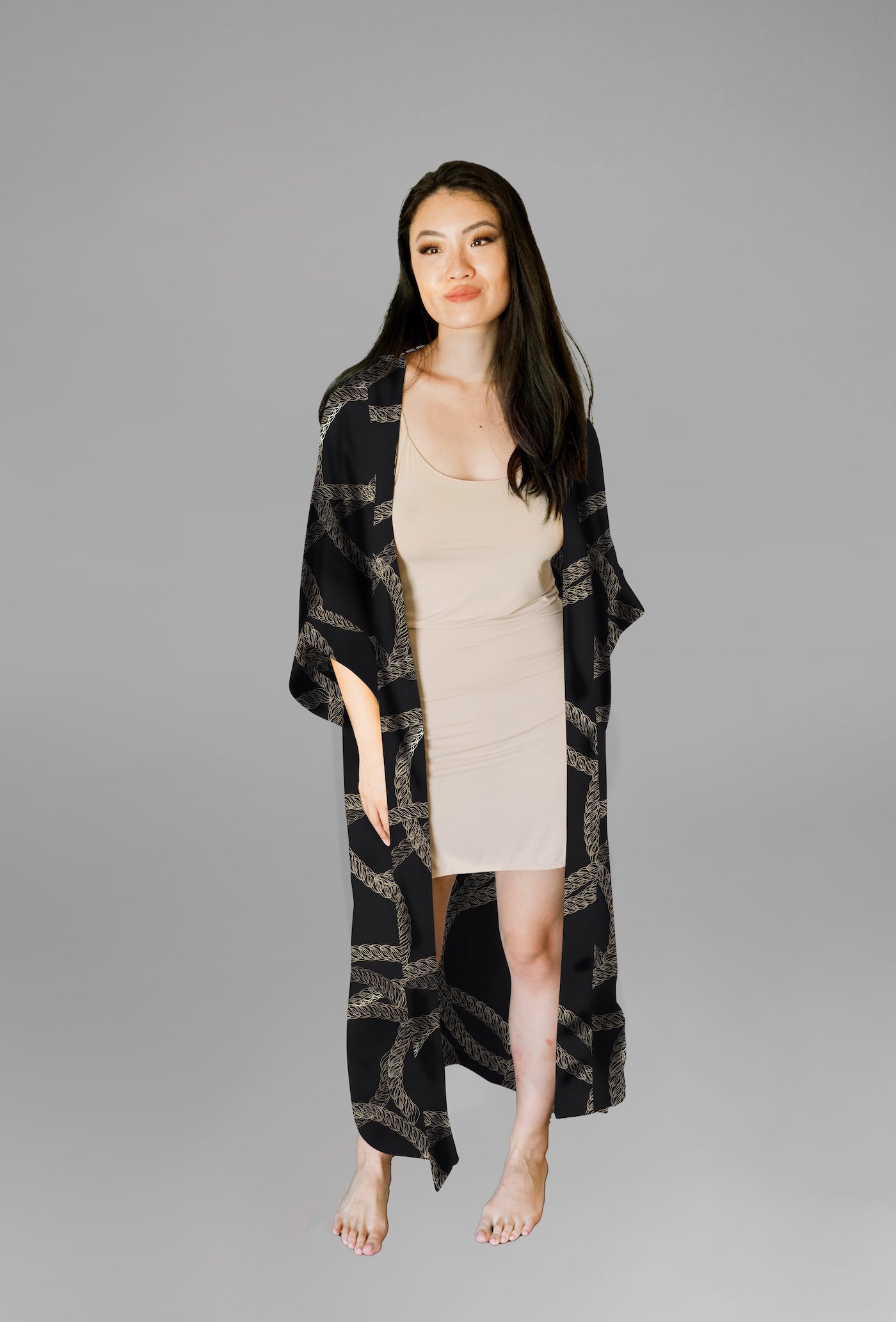 Woman wearing kimono robe in Justine front view with robe open overtop a nude slip dress hand in pocket