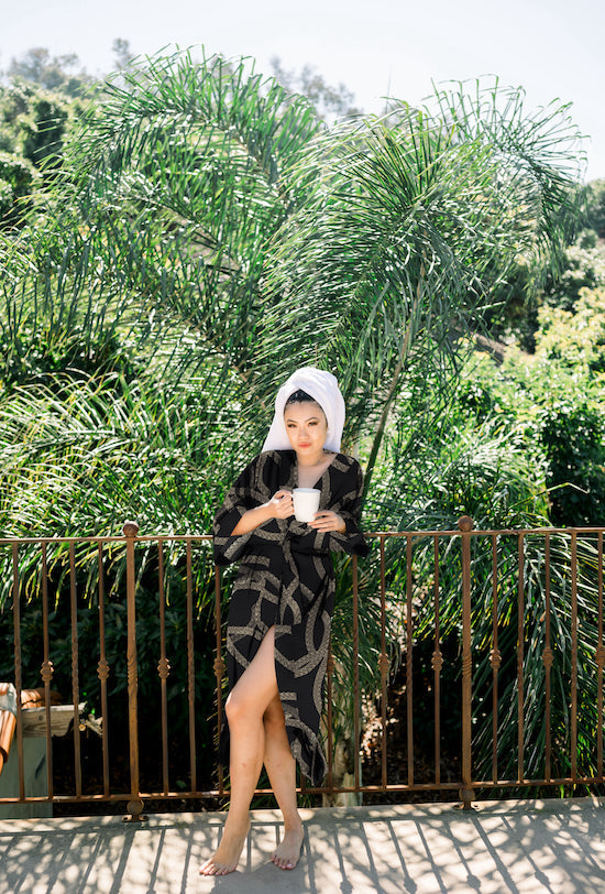 Woman wearing kimono robe in Justine outside with towel on her head