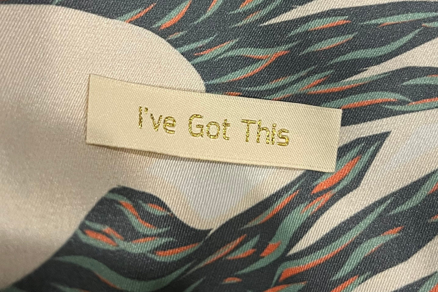 Close up view of kimono robe tag in navy toucans