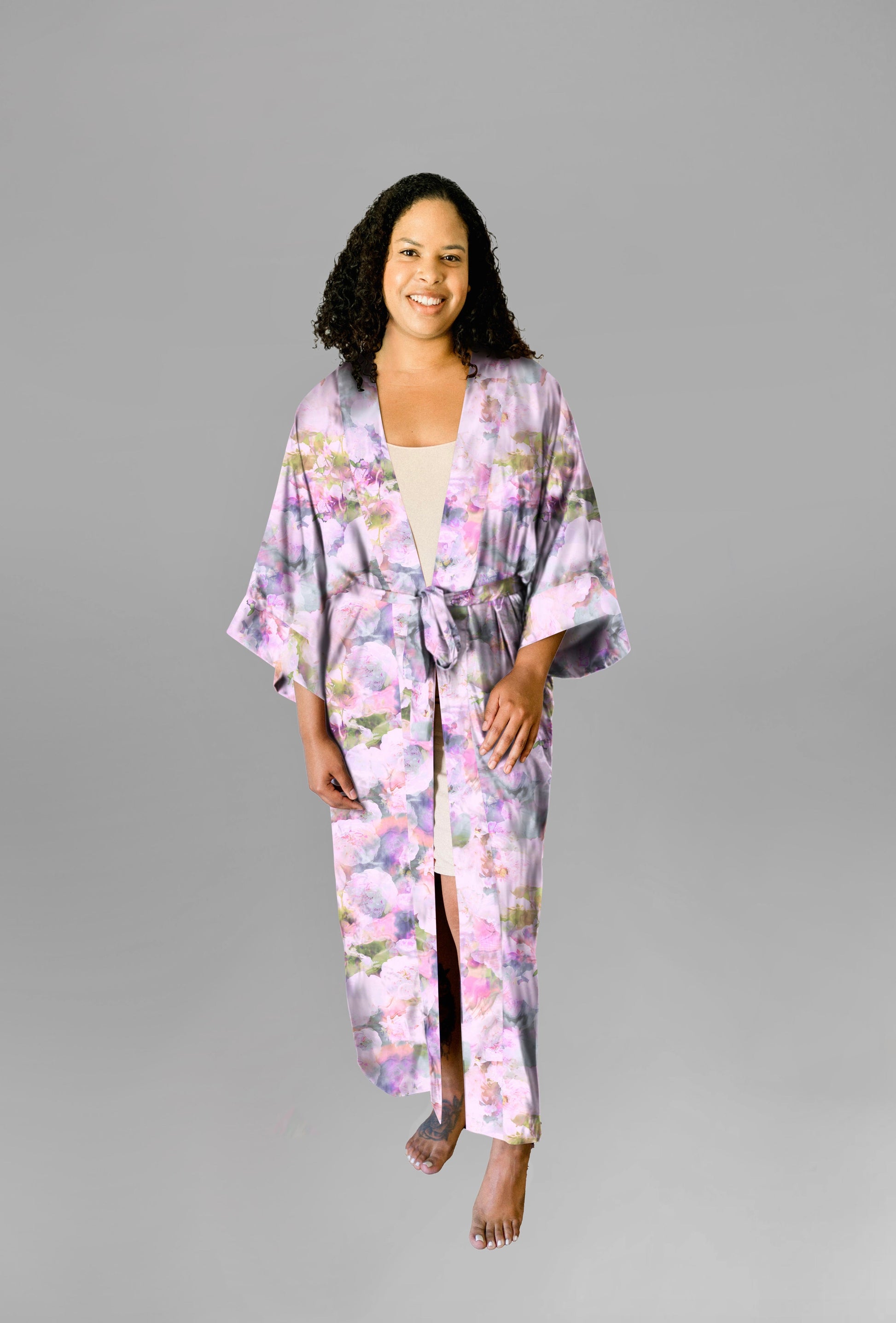 Woman wearing kimono robe in Pink Poppy with one hand in her pocket