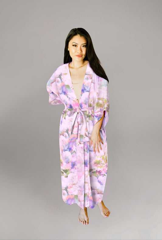 Woman wearing kimono robe in Pink Poppy with hand at her side