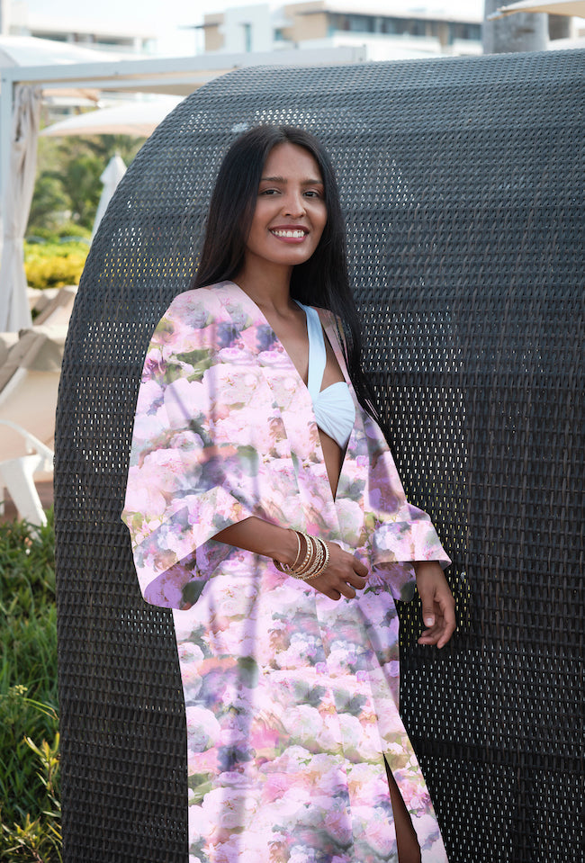 Woman wearing kimono robe in Pink Poppy outside with hand at her belt