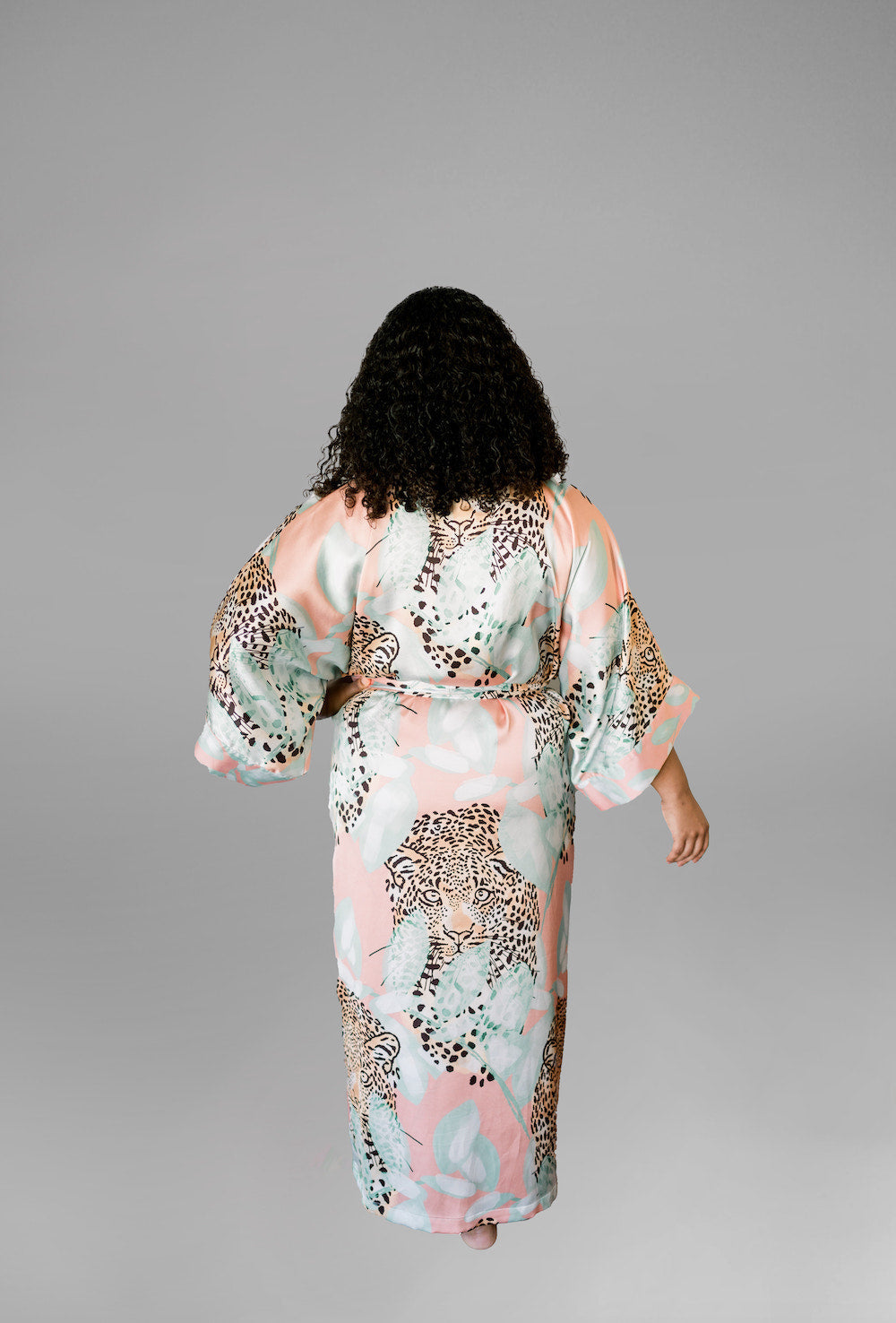Woman wearing kimono robe in Valencia back view one hand at her side