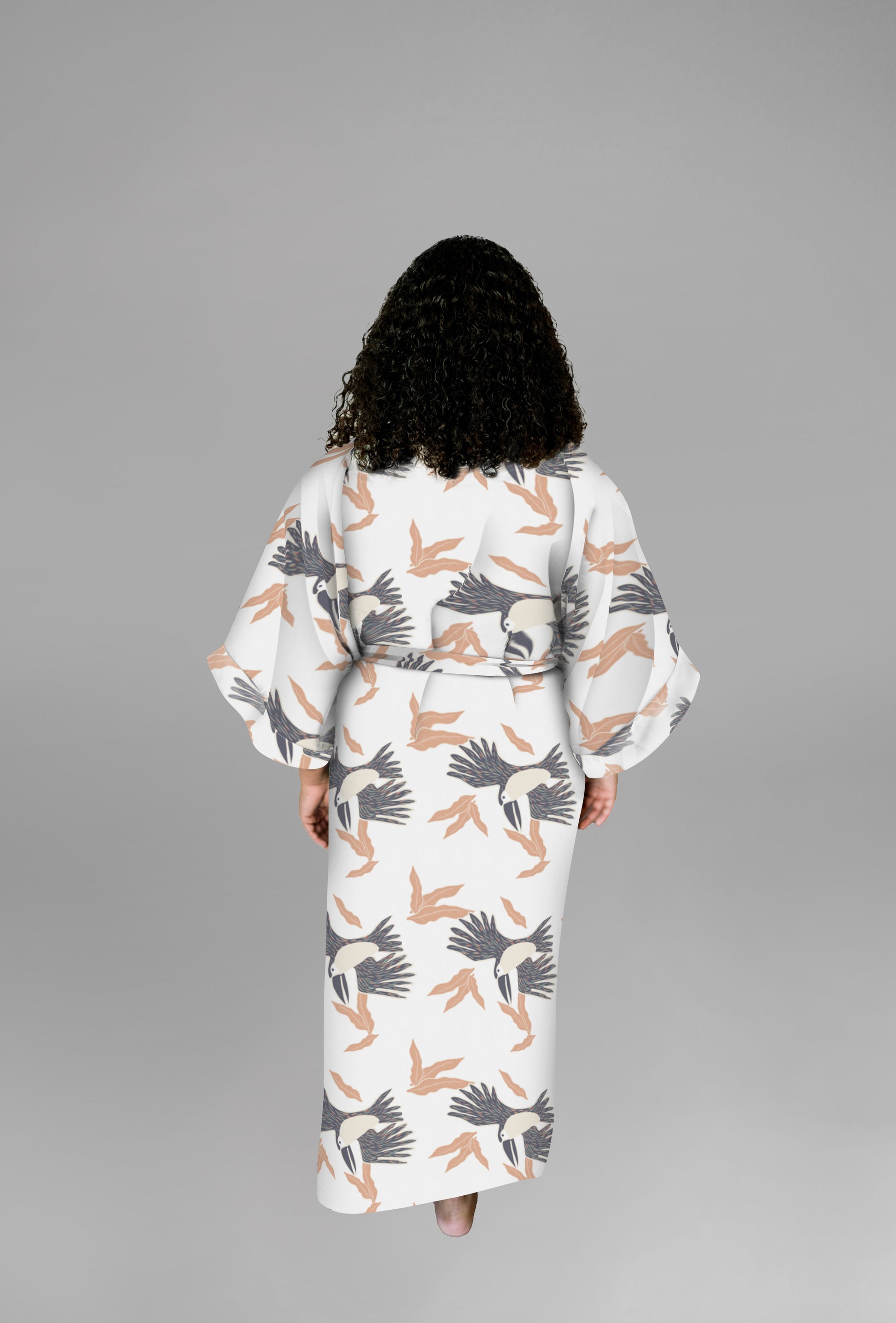 Woman wearing kimono robe in White Toucans back profile view hands at her side