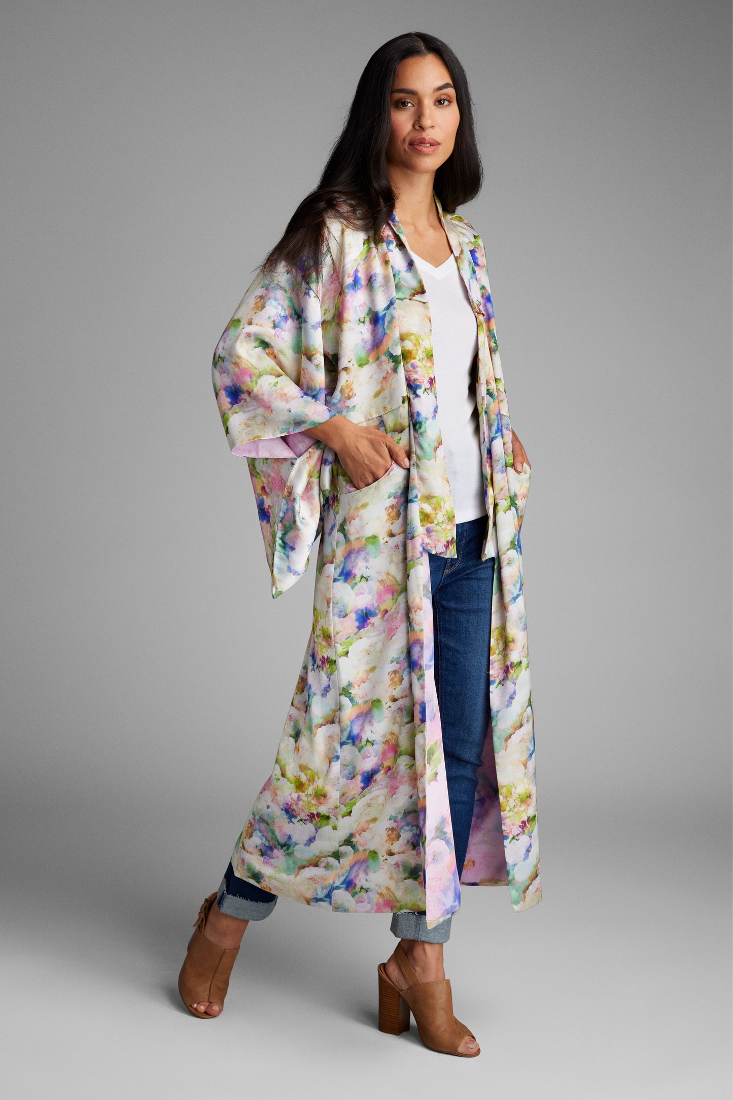 Front profile of woman wearing an all over floral printed kimono duster made from recycled textiles 2