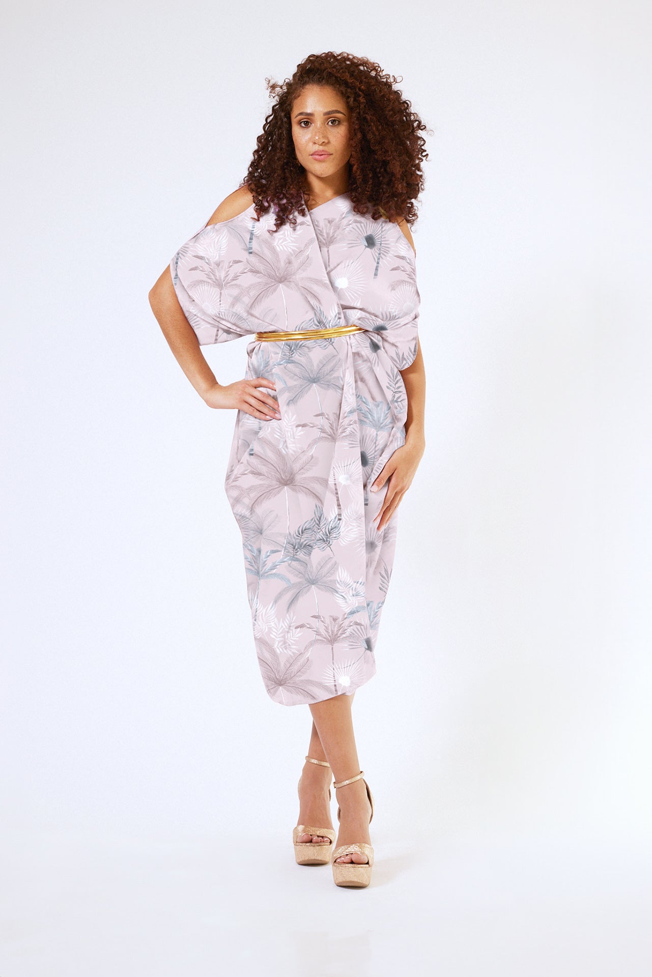 front view of woman wearing all over blush tropical print kaftan duster with front zipper made from recycled materials 4