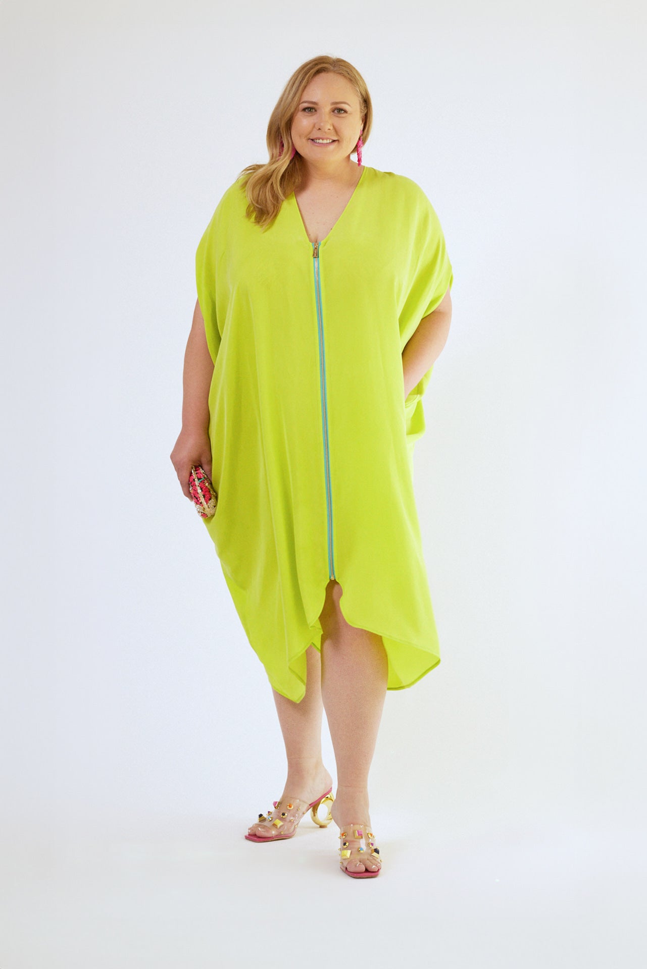 front view of woman wearing bright yellow kaftan duster with front zipper made from recycled materials 5