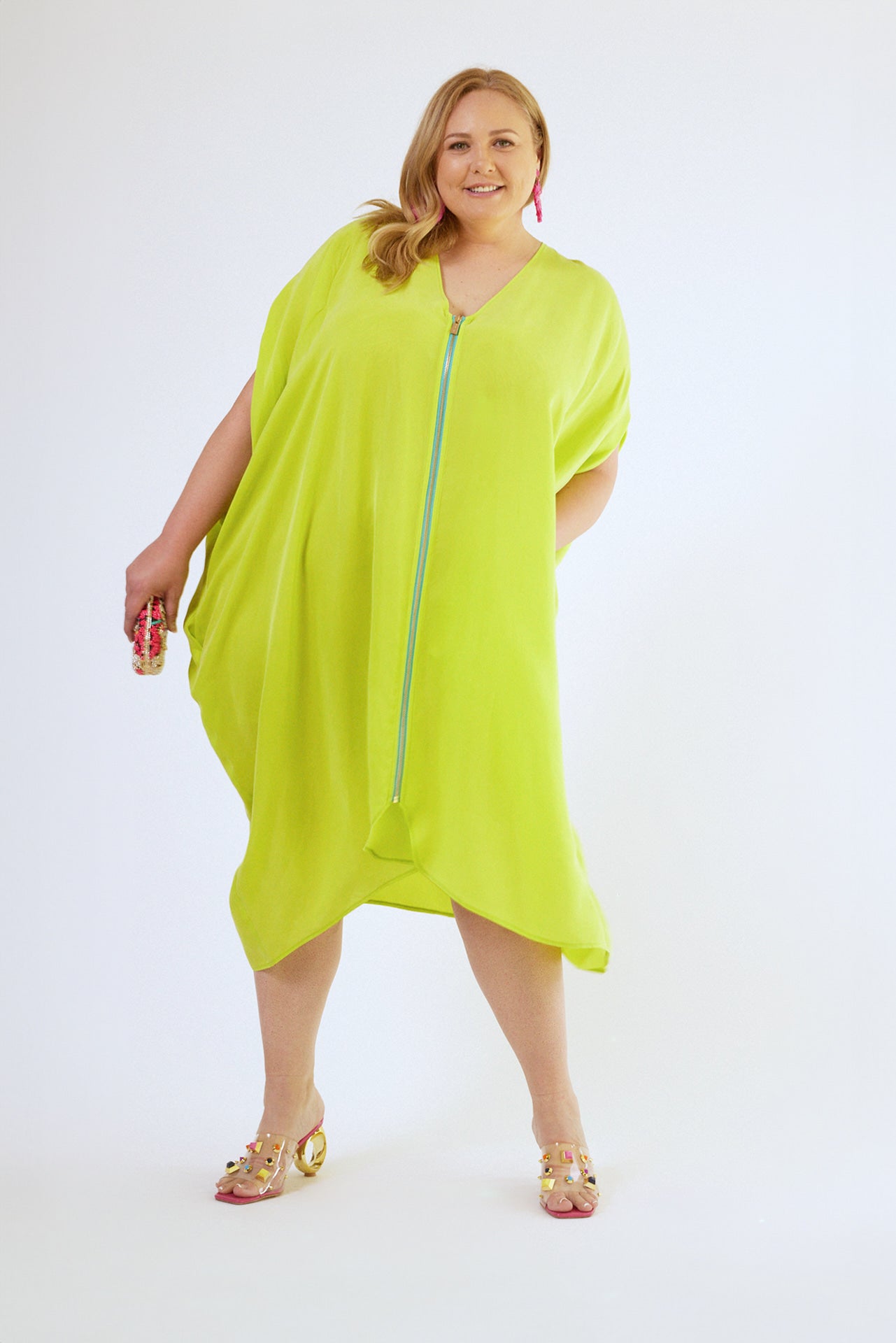 front view of woman wearing bright yellow kaftan duster with front zipper made from recycled materials 6