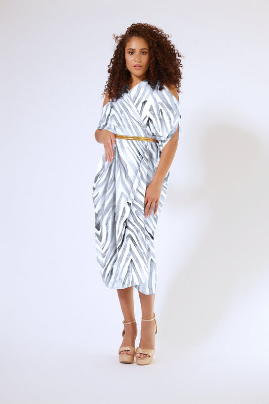front profile of woman wearing an all over grey zebra print kaftan duster with zipper made from recycled materials
