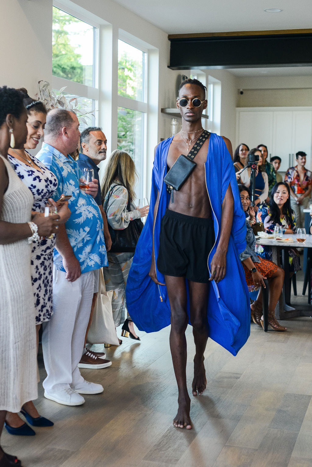 man modelling a royal blue kaftan duster with front zipper made from recycled materials