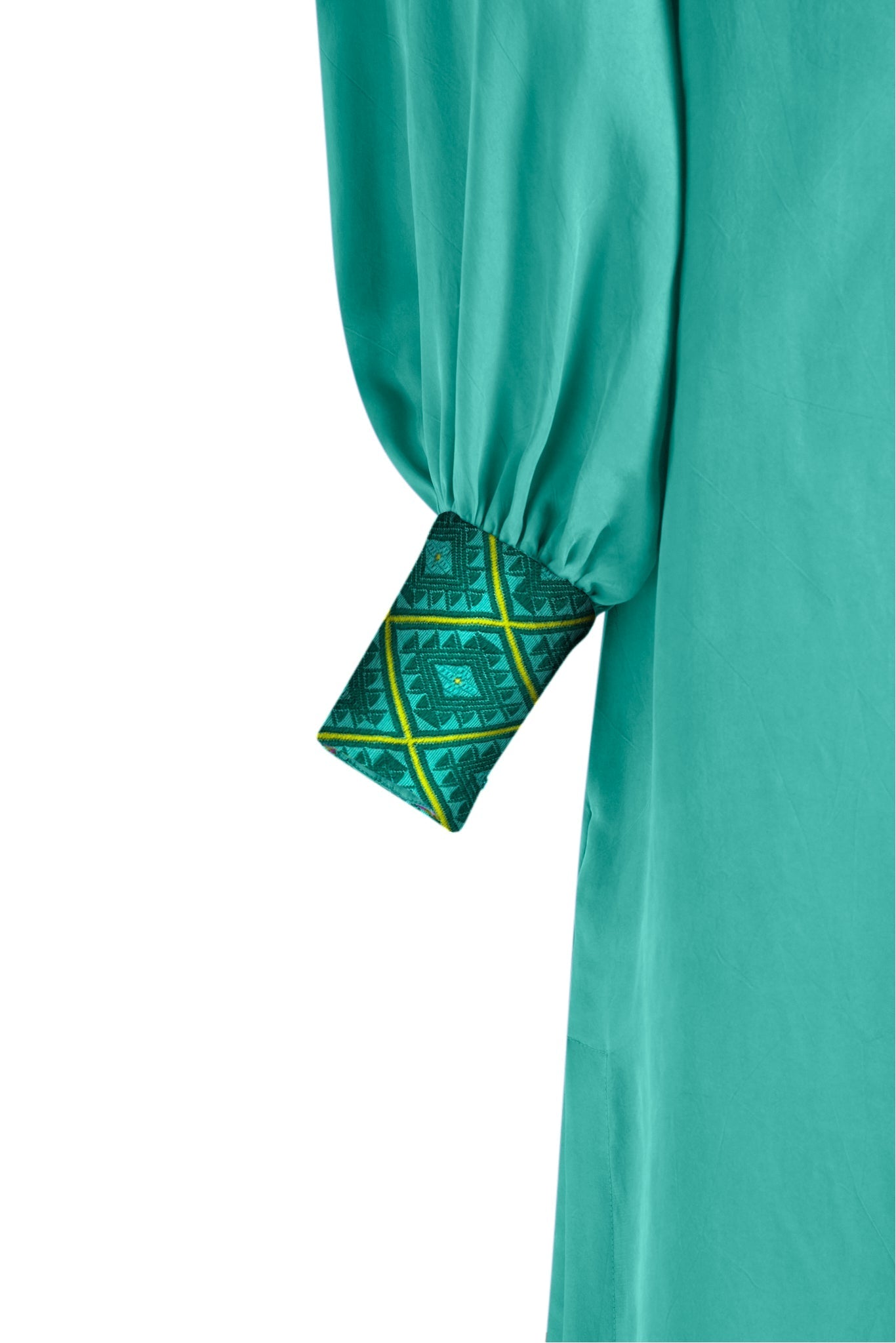 close up view turquoise kaftan duster with embroidered sleeves made from recycled materials