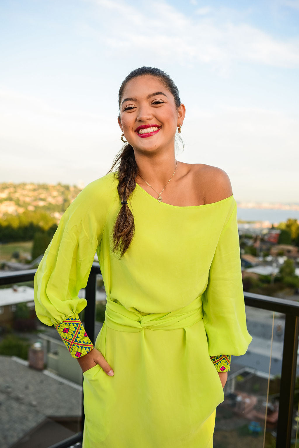 front profile view of woman modelling a bright yellow kaftan duster with embroidered sleeves made from recycled materials