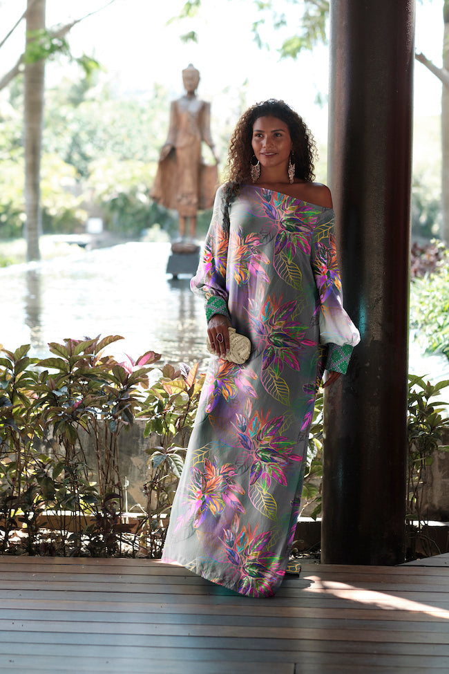 woman wearing all over tropical printed kaftan duster with embroidered cuffs made from recycled materials 2