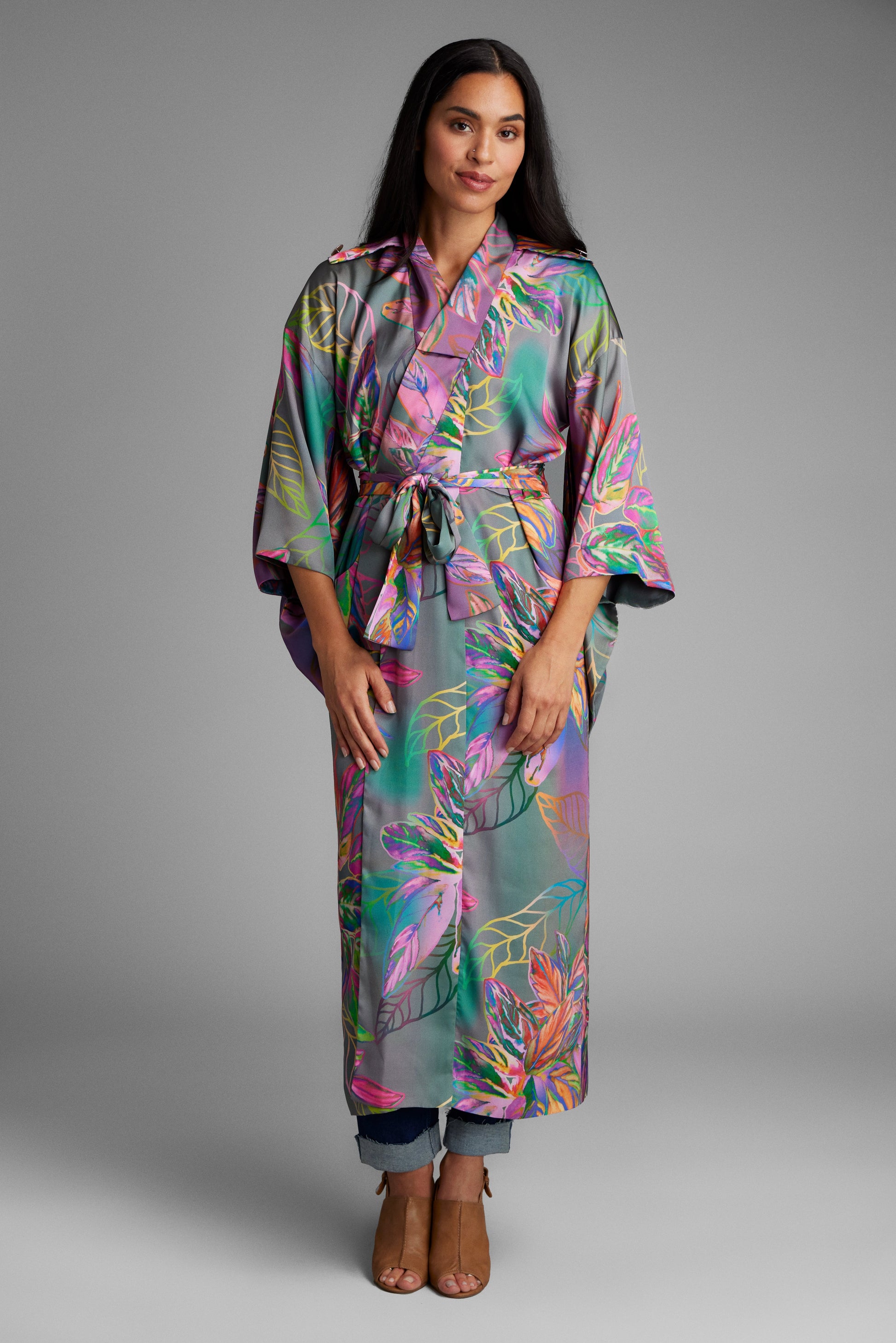 Woman standing wearing an all over tropical printed kimono duster made from recycled materials 3