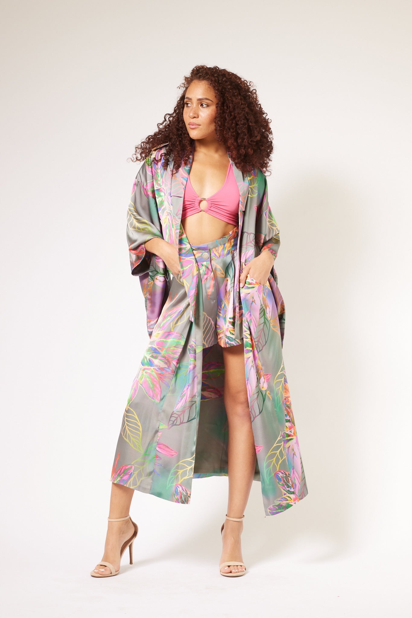 Front profile of woman modelling tropical printed tulips shorts and kimono duster made from recycled materials 5