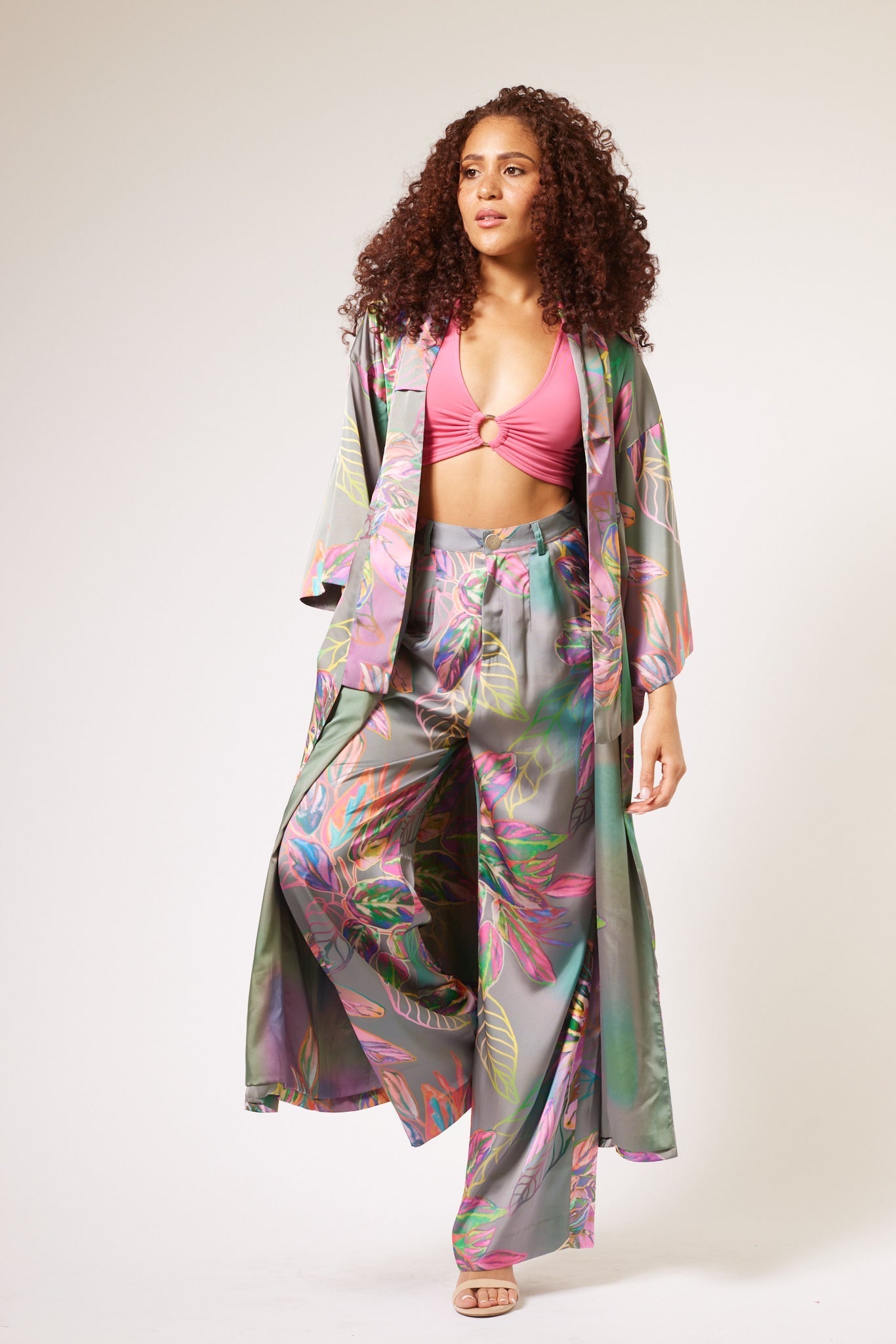 woman modelling all over multicolored tropical print kimono duster and matching yacht slacks made with recycled textiles 3