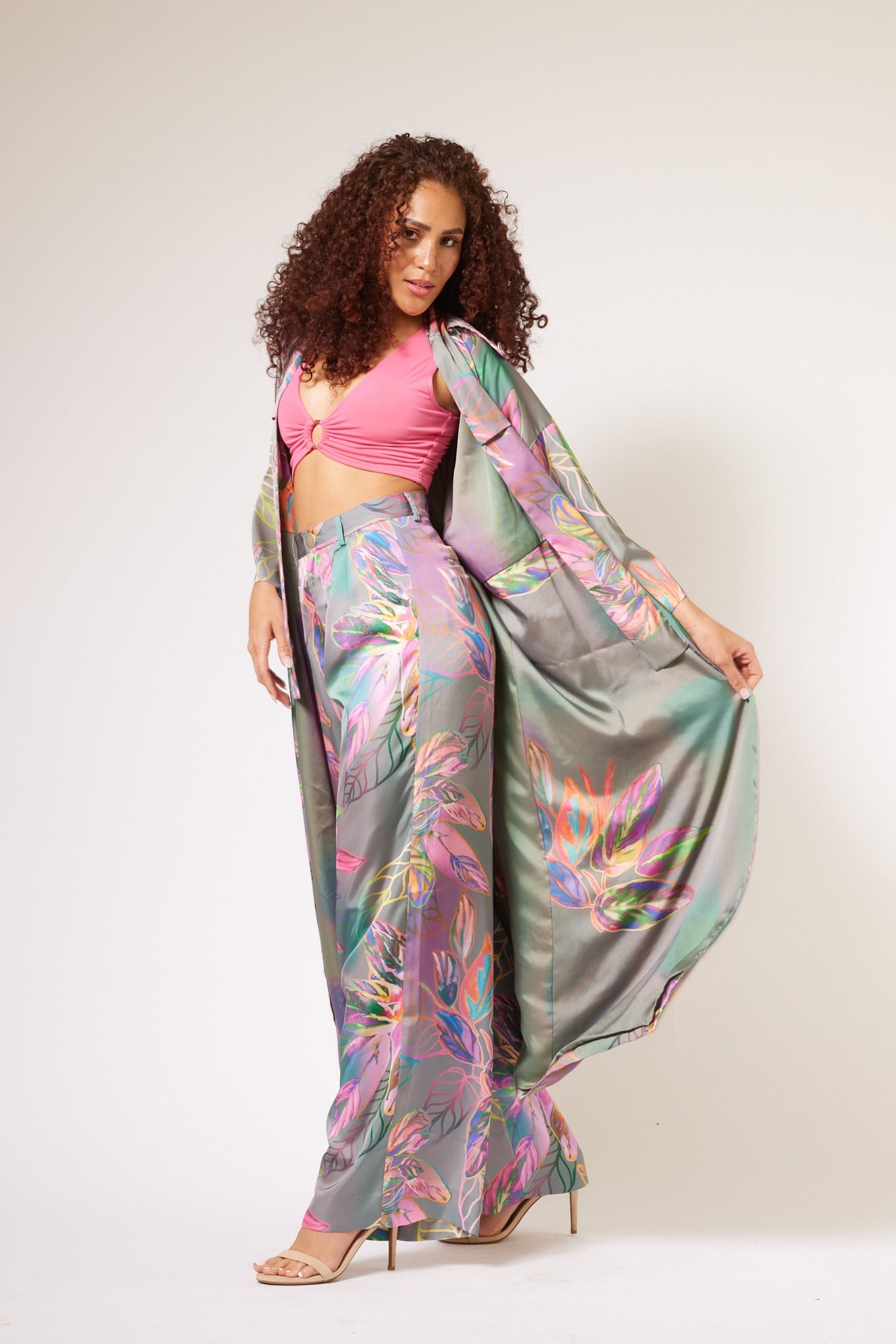 woman modelling all over multicolored tropical print kimono duster and matching yacht slacks made with recycled textiles 4