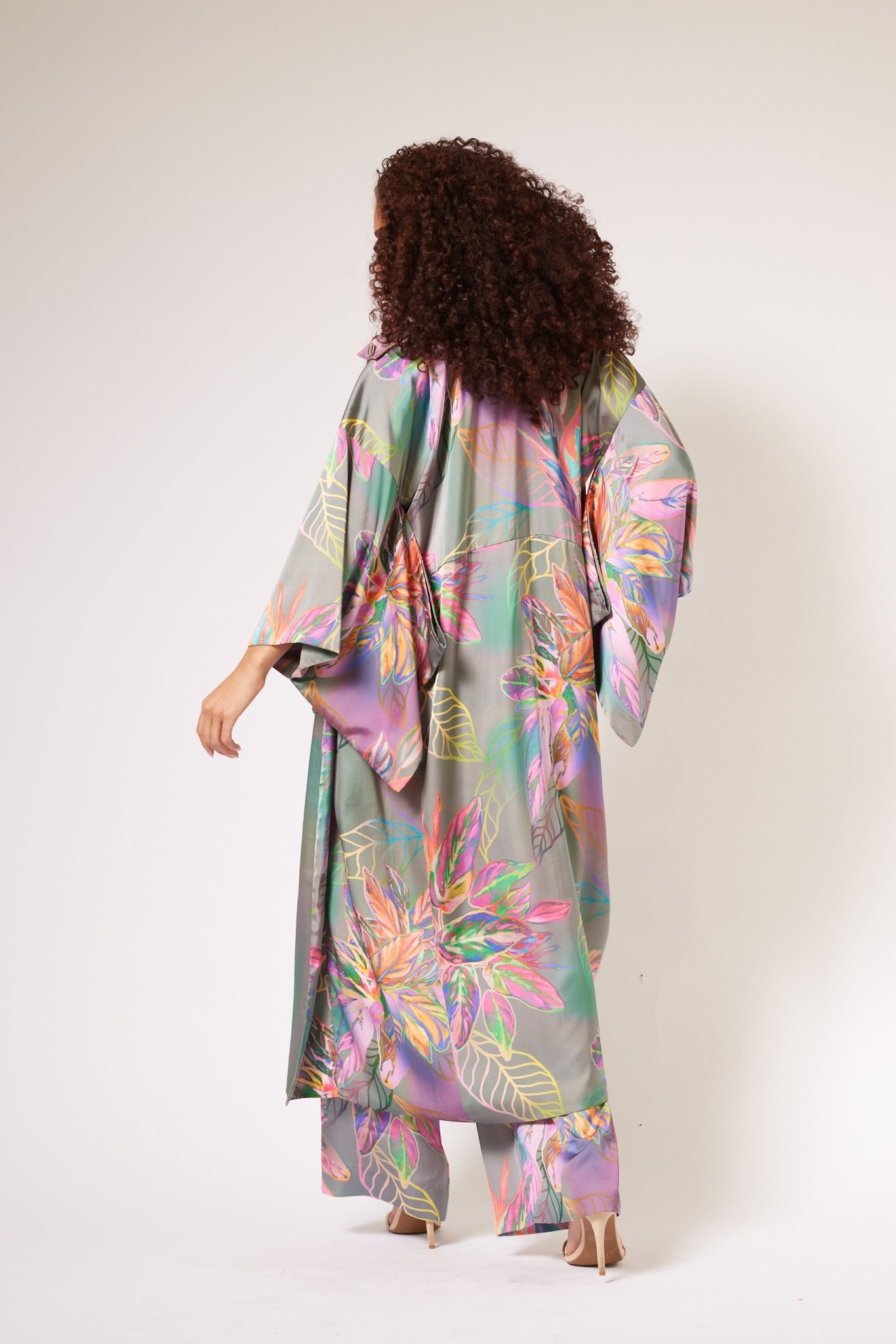 back profile of woman modelling all over multicolored tropical print kimono duster and matching yacht slacks made with recycled textiles 2