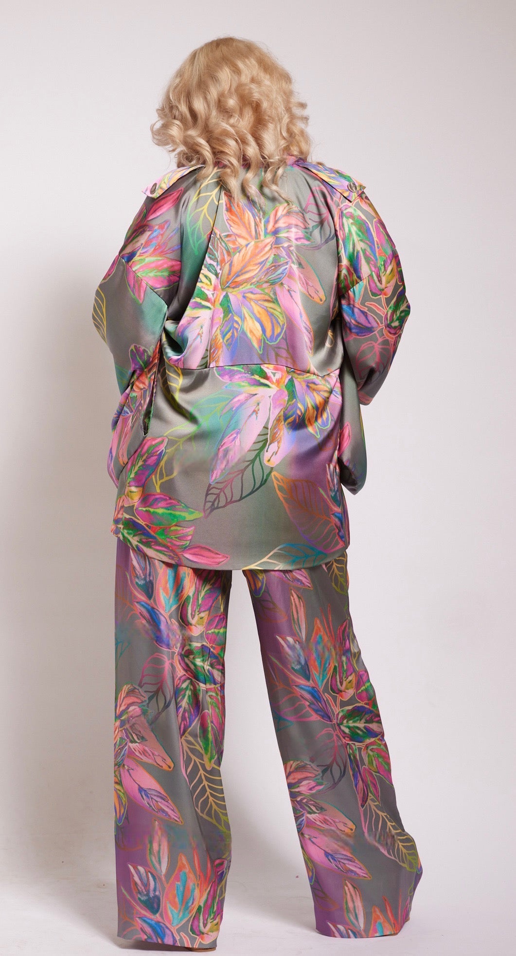 back profile of woman wearing all over multicolored tropical print yacht pants and matching kimono duster