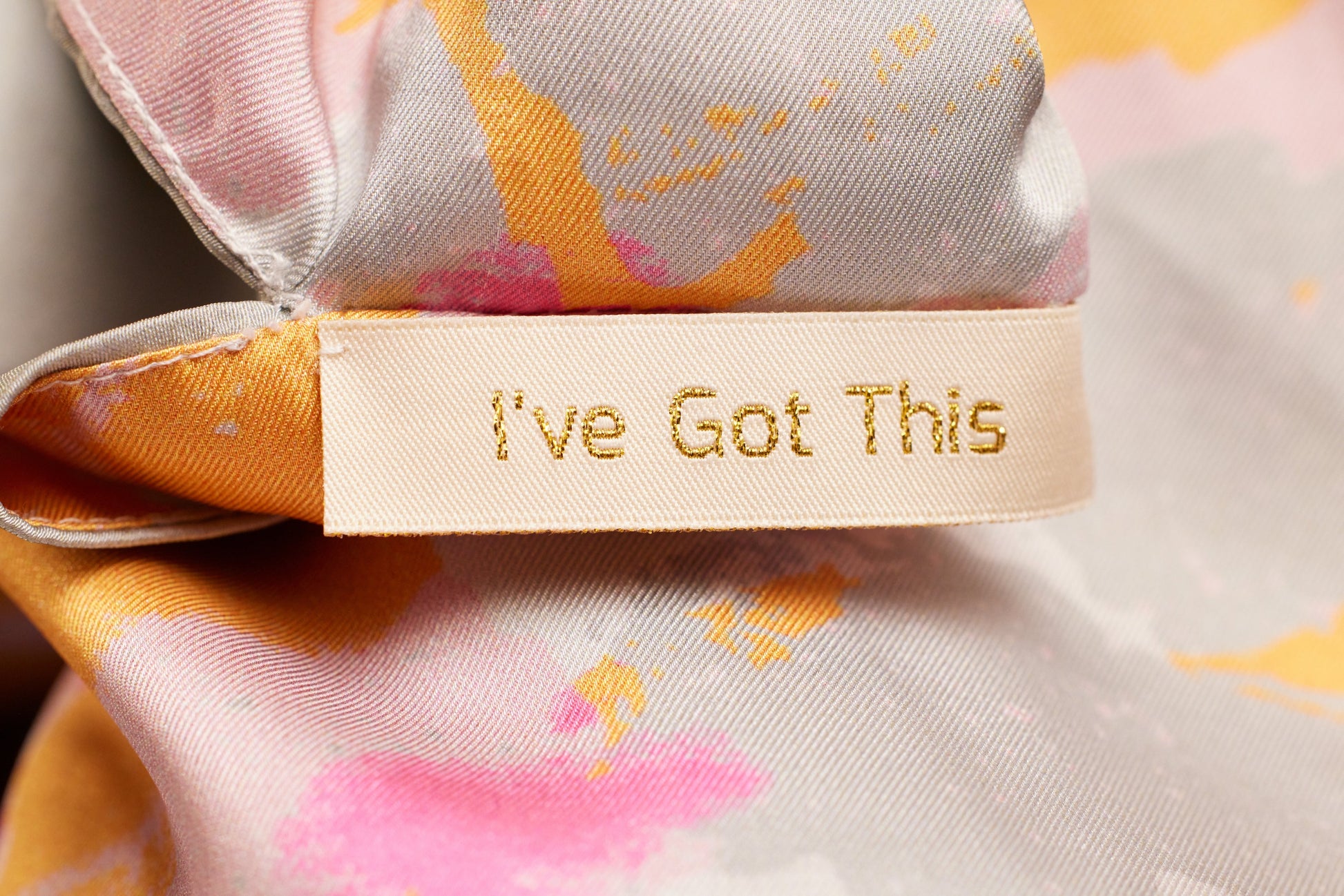Article of clothing with a tag showing a positive affirmation