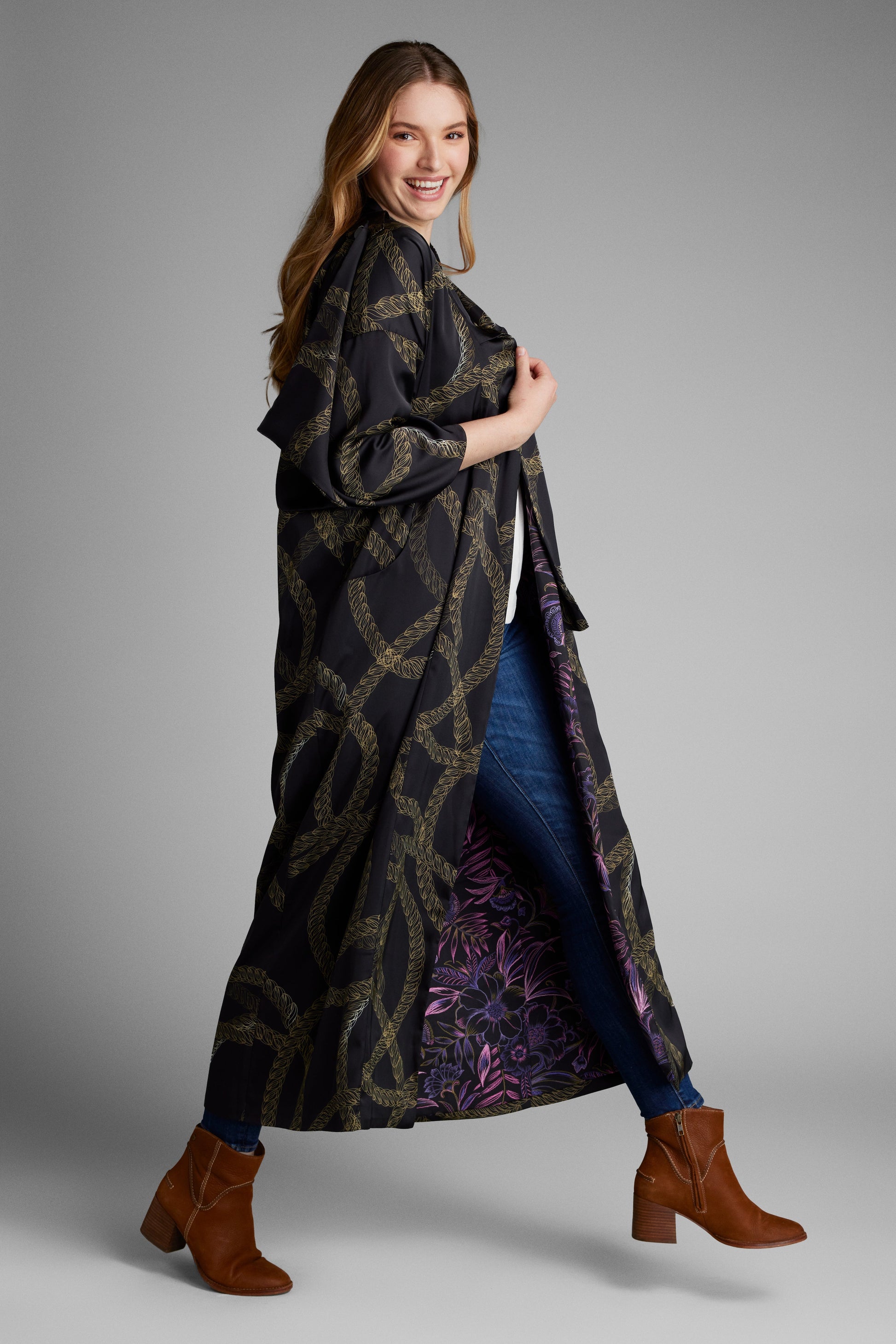 Side profile of woman wearing a black and gold chain print kimono duster made from recycled materials 4