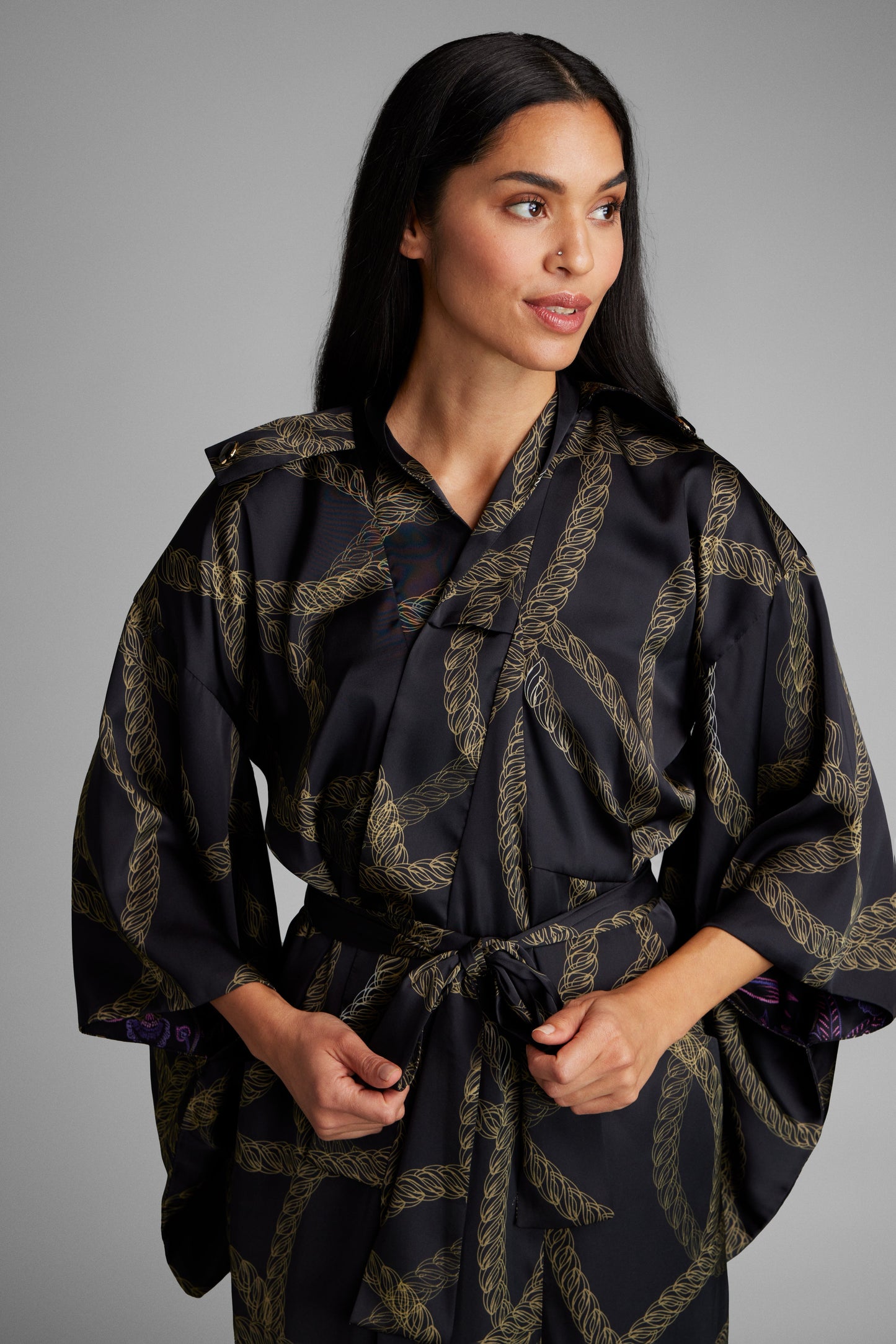 Woman modeling black and gold chain printed womens kimono duster made from recycled materials