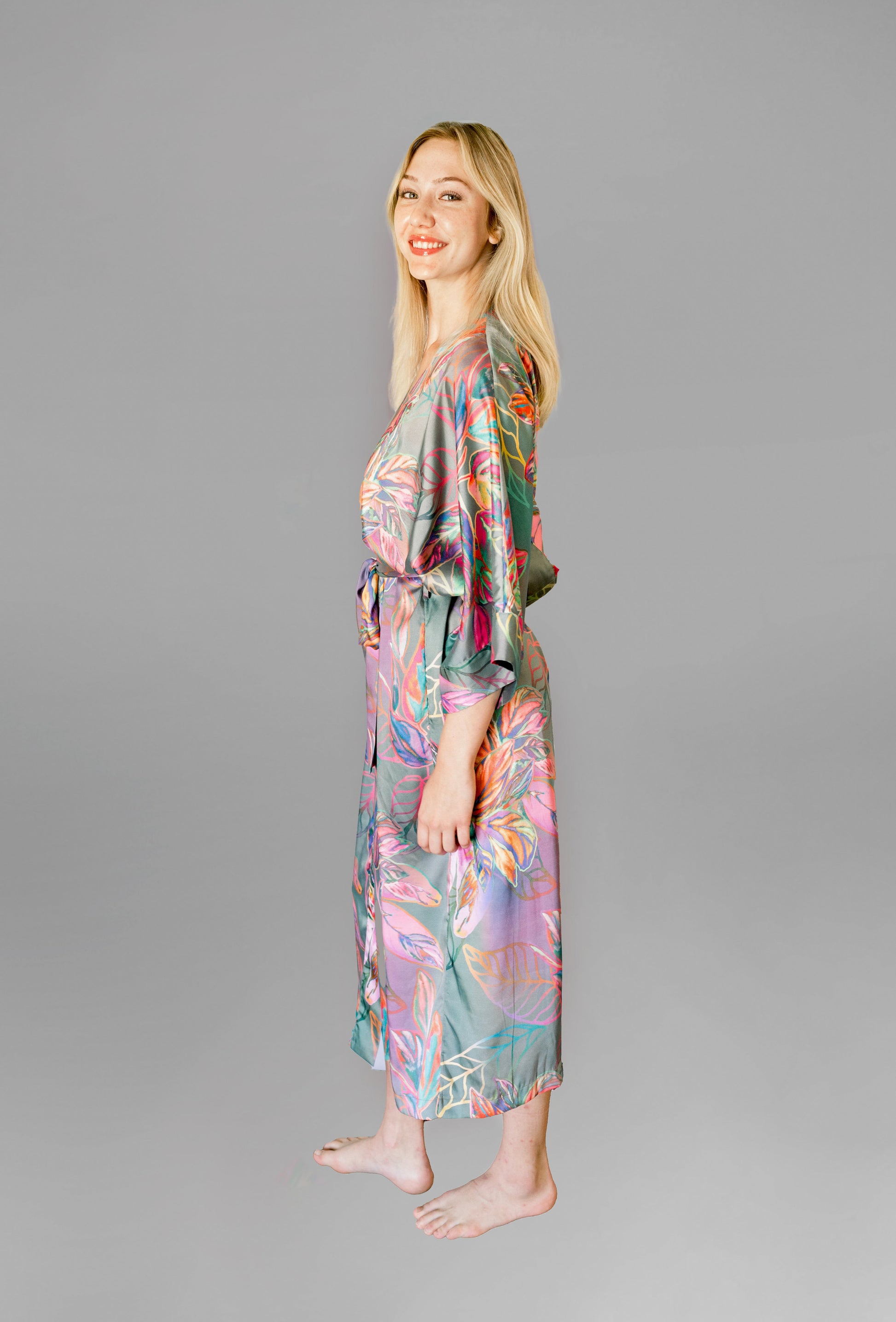 Woman wearing kimono robe in Carmen side profile with robe closed with hands at her side