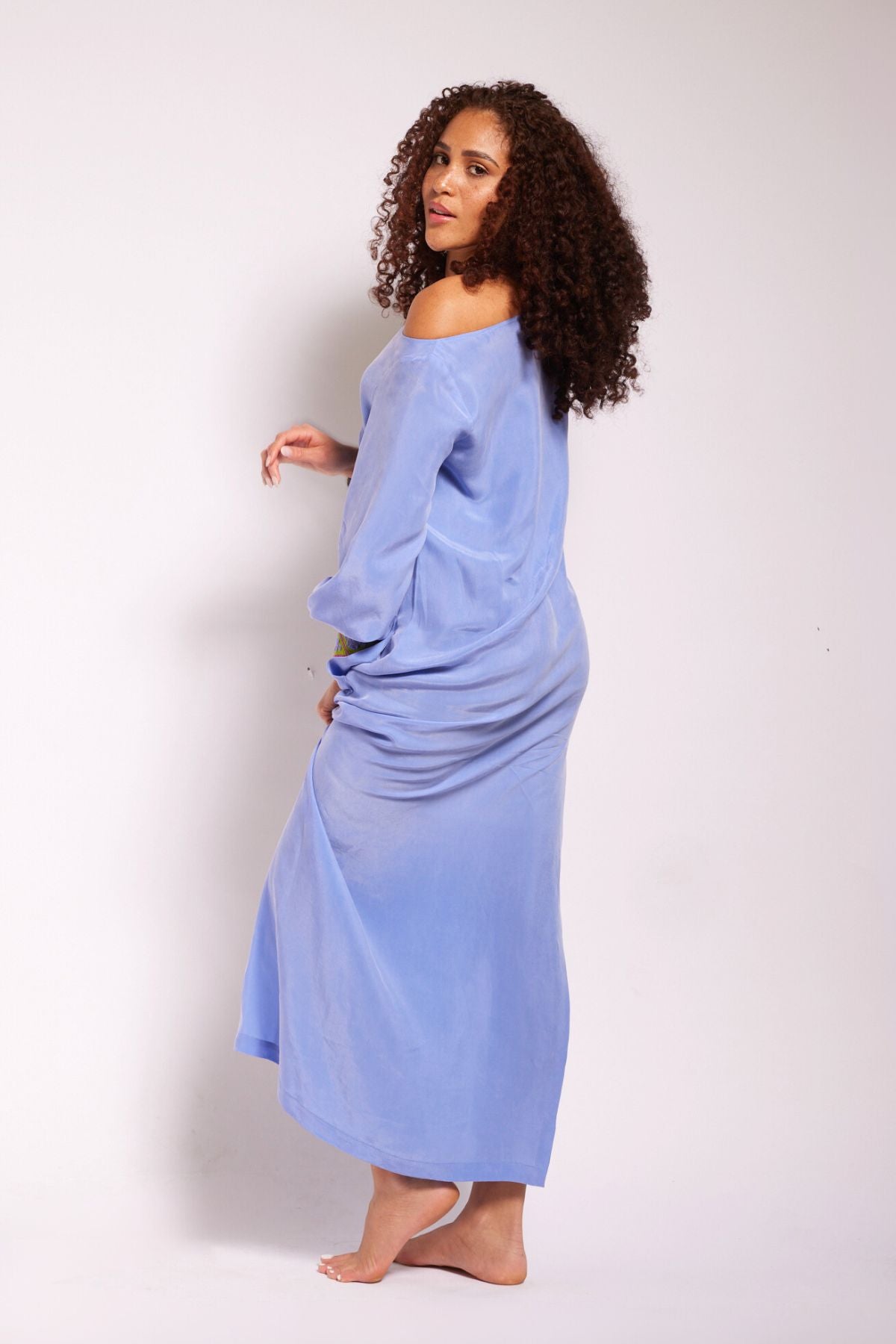 back view of woman wearing lavender kaftan duster with embroidered sleeves made from recycled materials 2