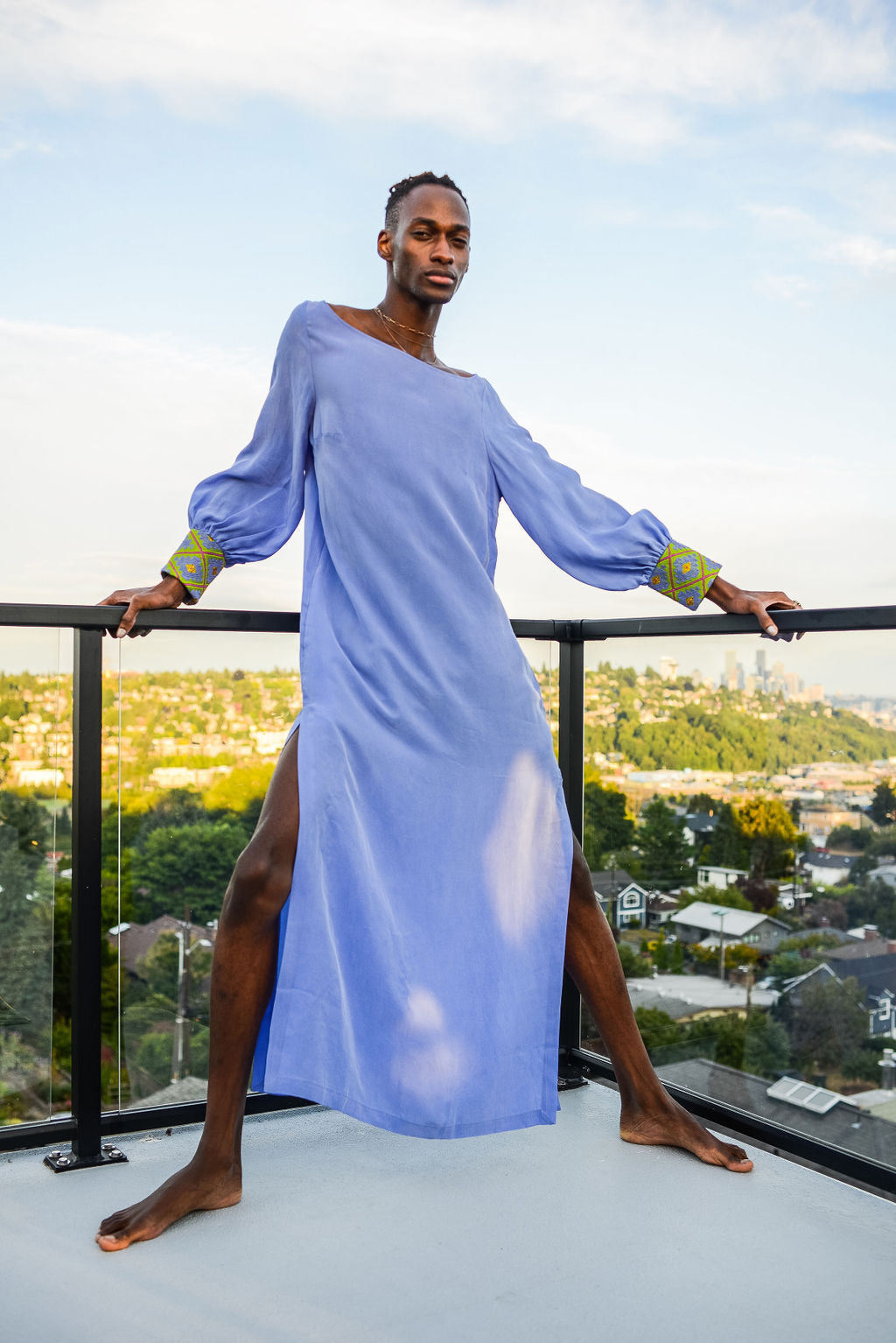 man modelling wearing lavender kaftan duster with embroidered sleeves made from recycled materials 3