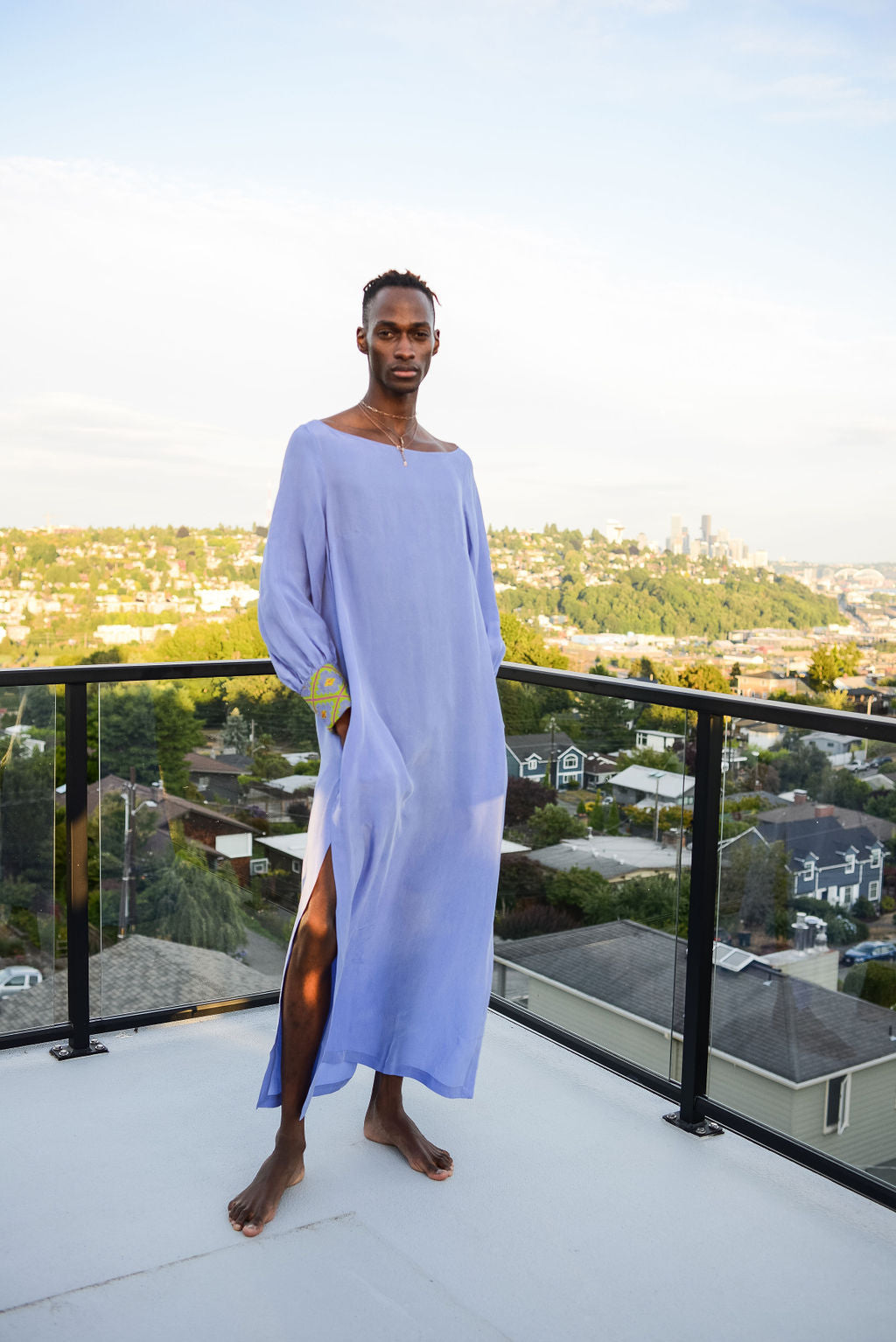 man modelling wearing lavender kaftan duster with embroidered sleeves made from recycled materials 4