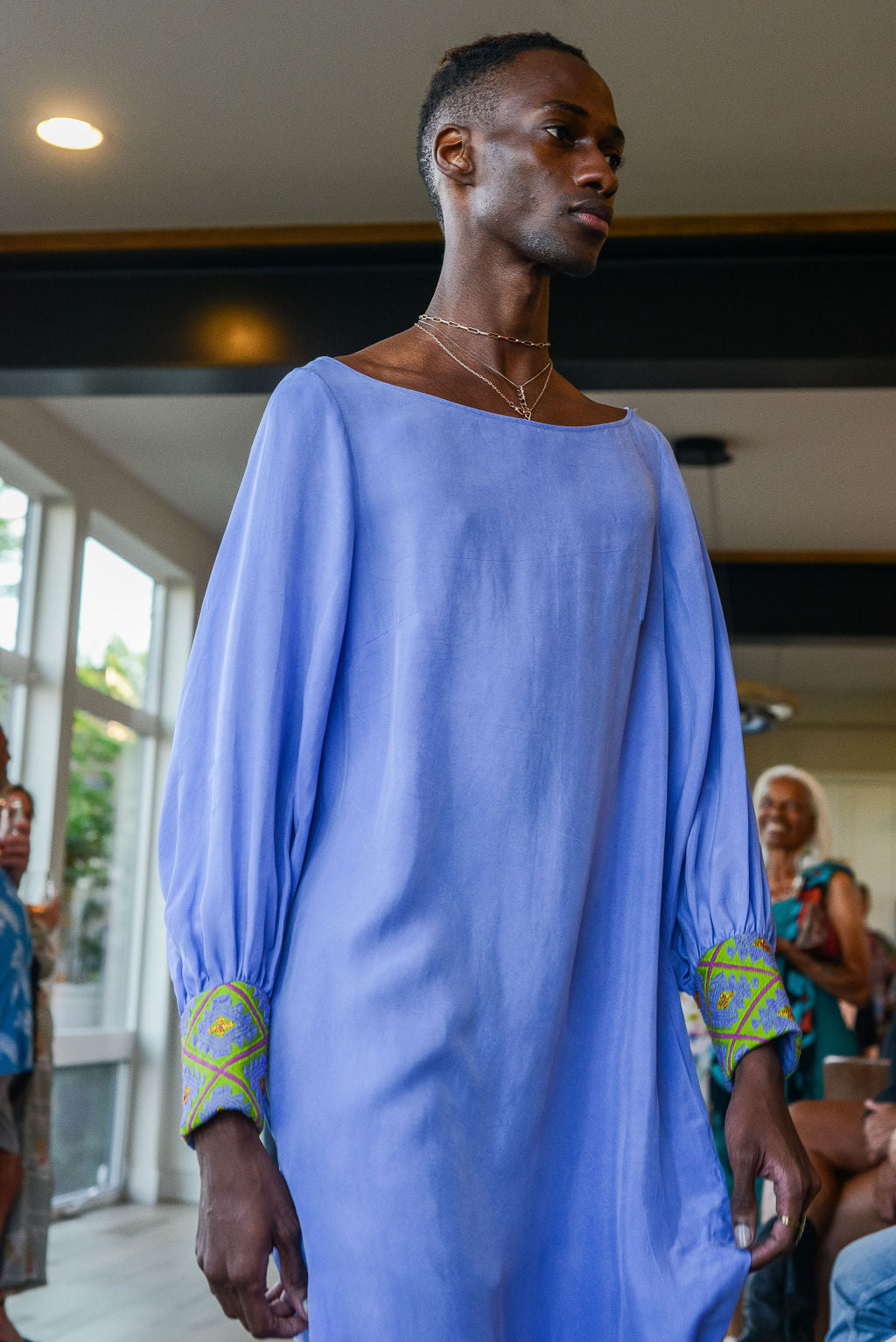 man modelling wearing lavender kaftan duster with embroidered sleeves made from recycled materials 2
