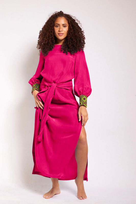 woman modelling a magenta kaftan duster with embroidered sleeves made from recycled materials