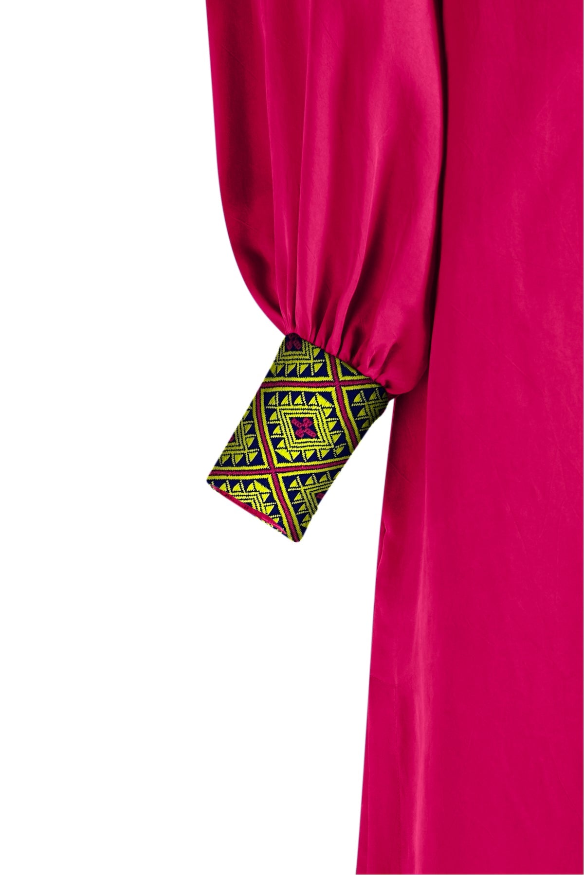 close up view of magenta kaftan duster with embroidered sleeves made from recycled materials