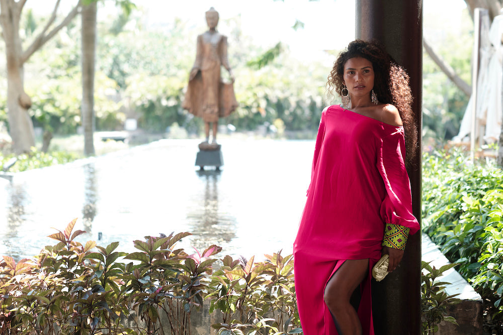 woman modelling a magenta kaftan duster with embroidered sleeves made from recycled materials 3