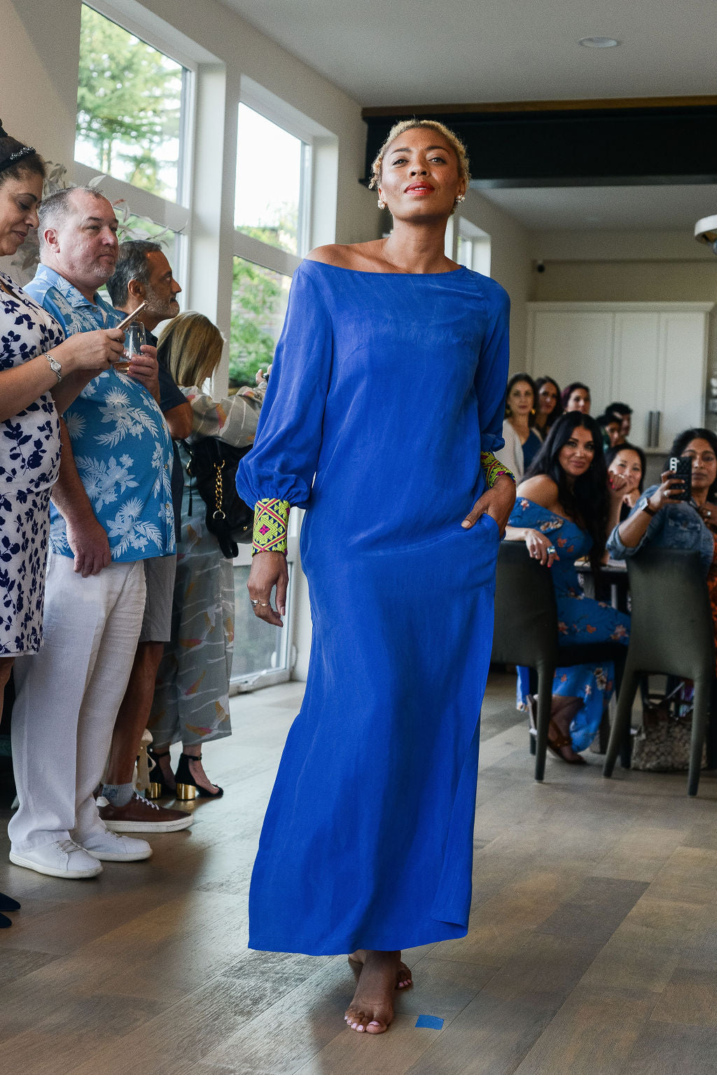 woman modelling a royal blue kaftan duster with embroidered sleeves made from recycled materials