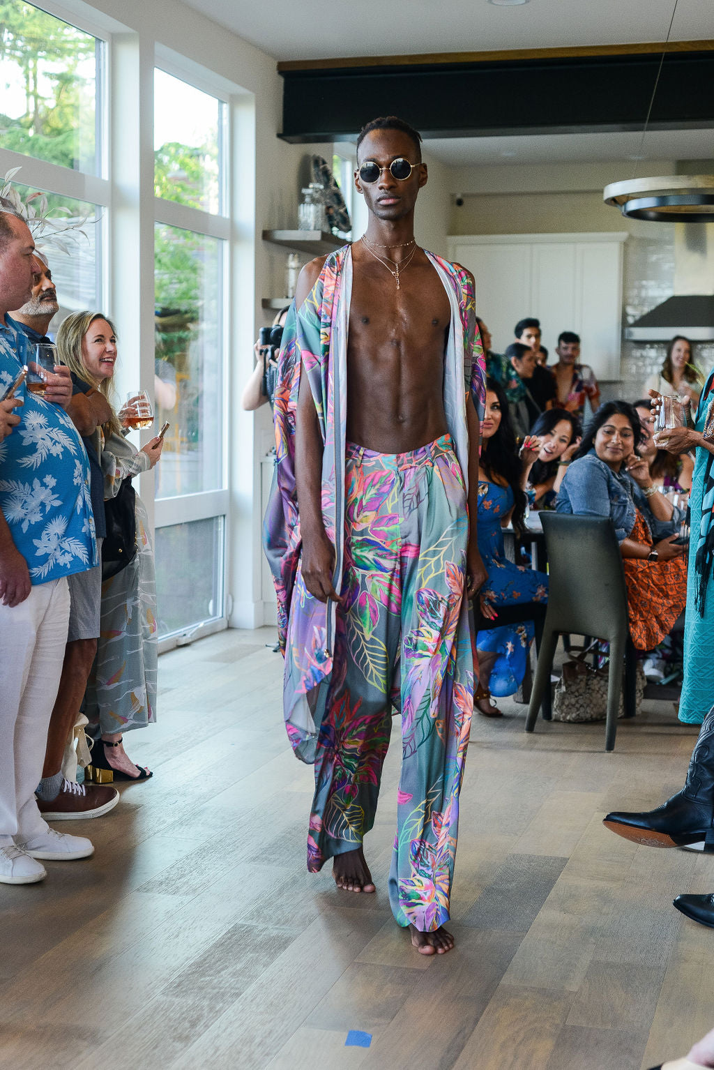 man modelling wearing all over tropical print kaftan duster with front zipper made from recycled materials