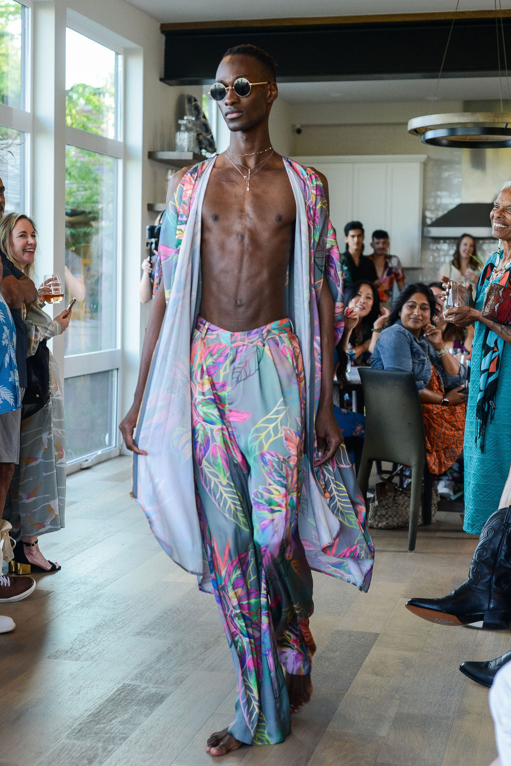 man modelling wearing all over tropical print kaftan duster with front zipper made from recycled materials 2