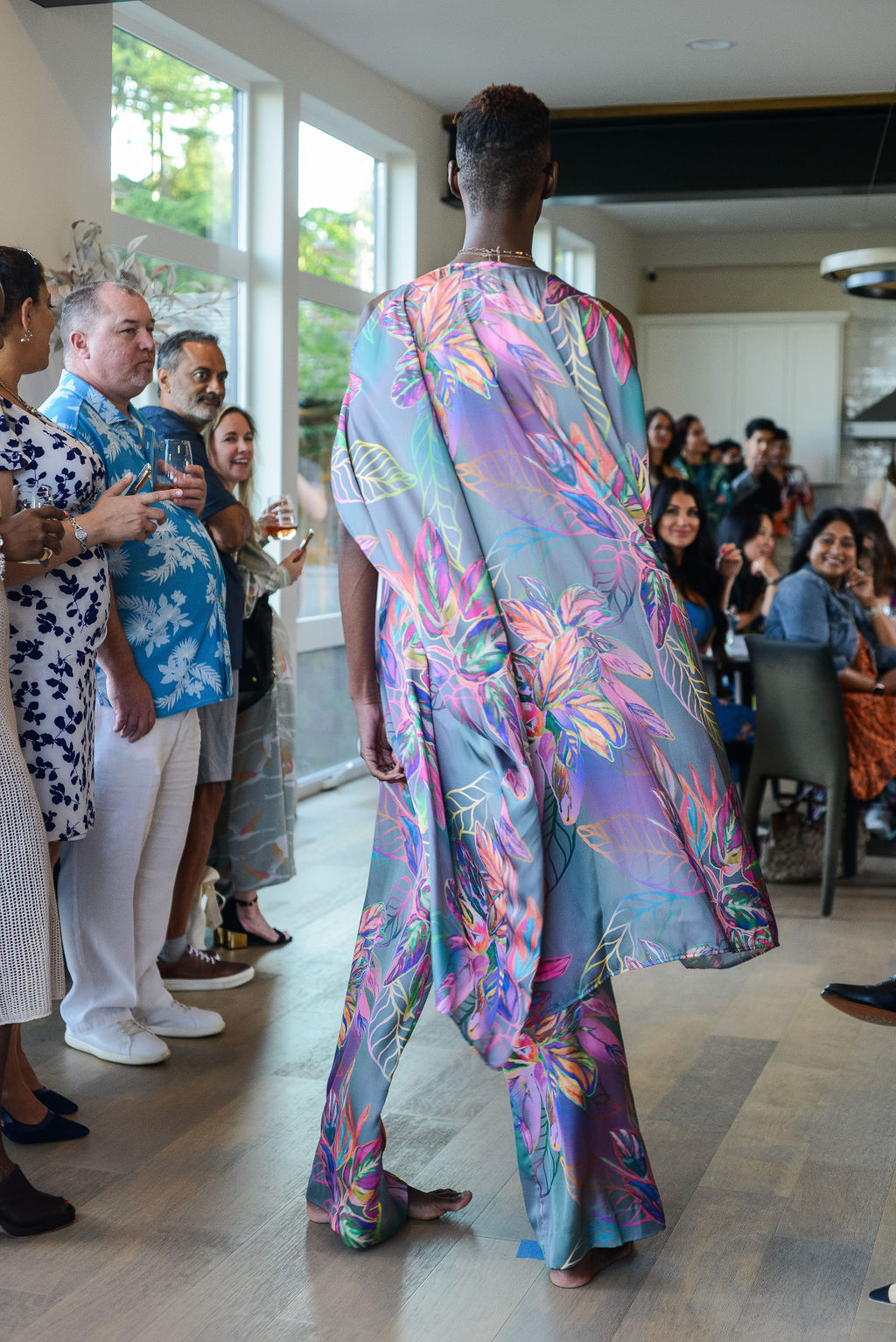 man modelling wearing all over tropical print kaftan duster with front zipper made from recycled materials 3