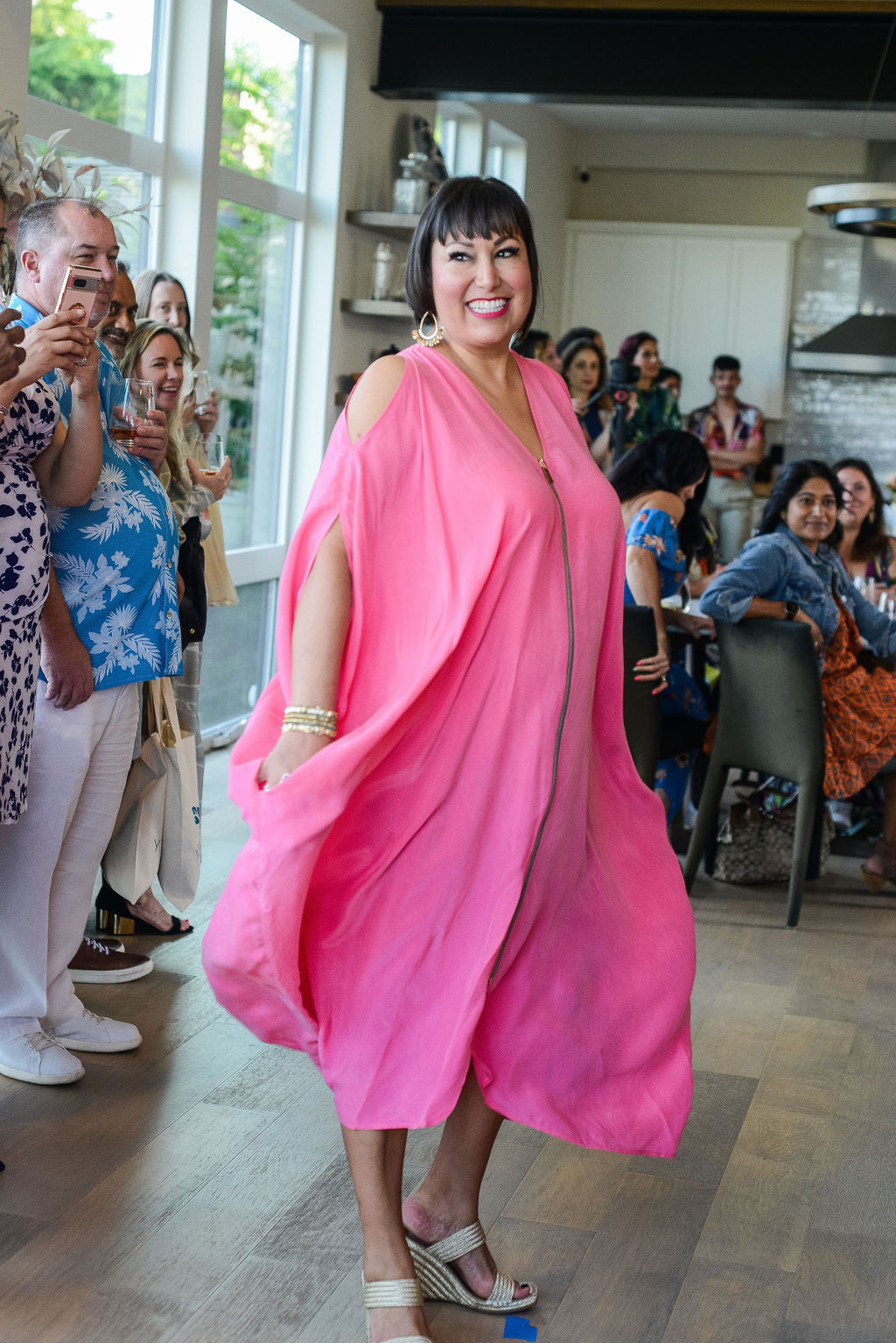 woman modelling wearing bubble gum pink kaftan duster with front zipper made from recycled materials