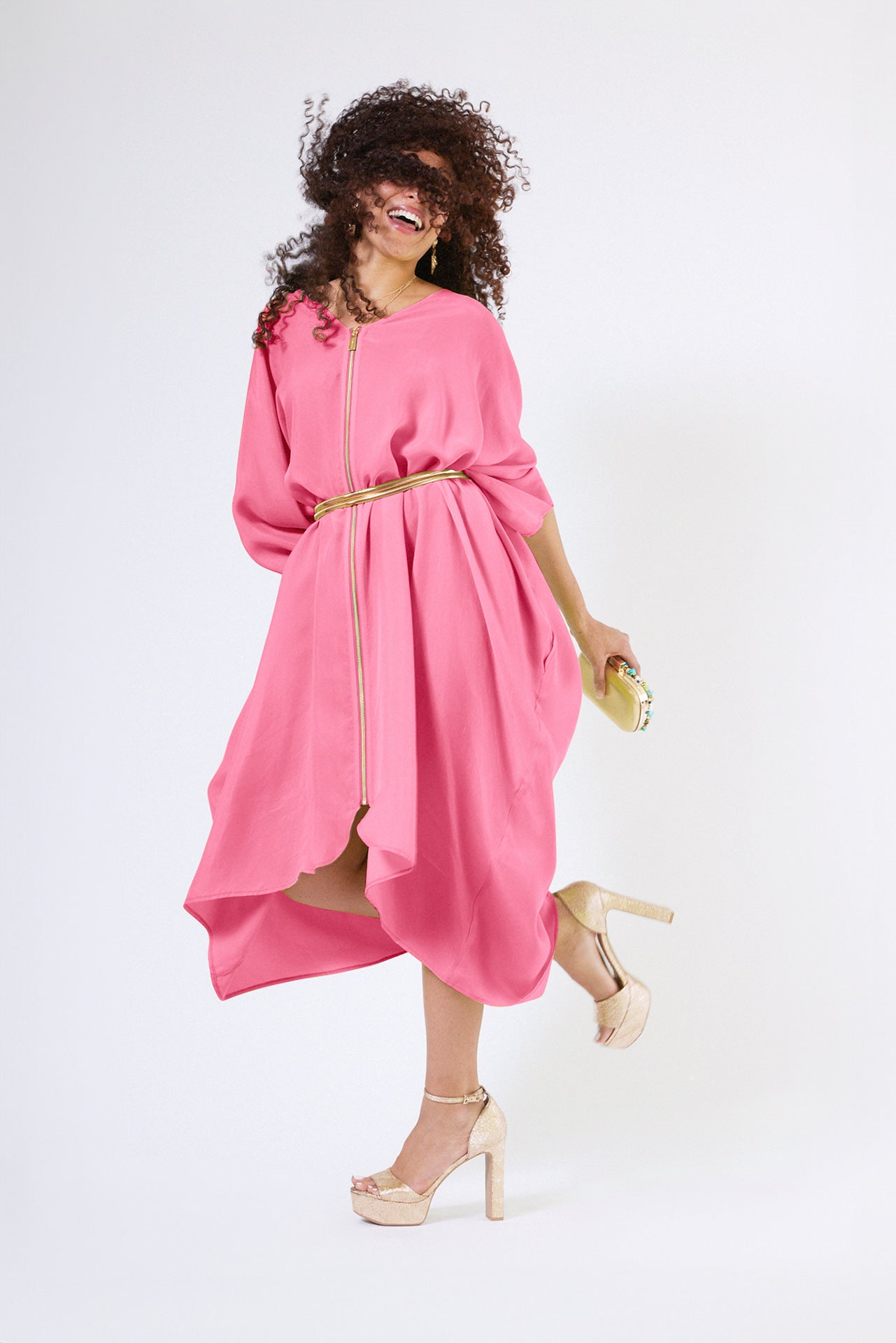 front view of woman wearing bubble gum pink kaftan duster with front zipper made from recycled materials 2