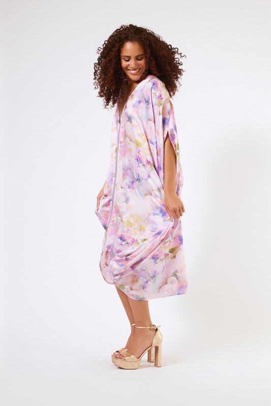 side profile view of woman wearing pink floral kaftan duster with zipper made from recycled materials