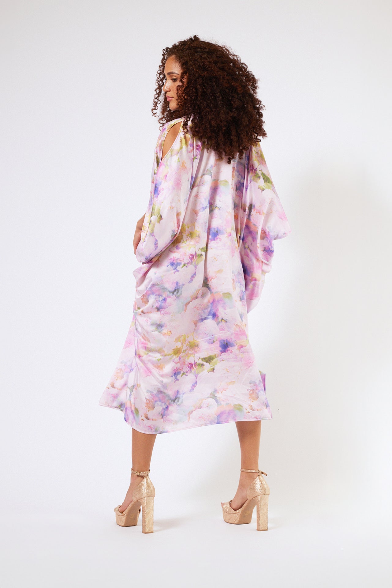 back profile of woman modelling pink floral kaftan duster with front zipper made from recycled textiles 2