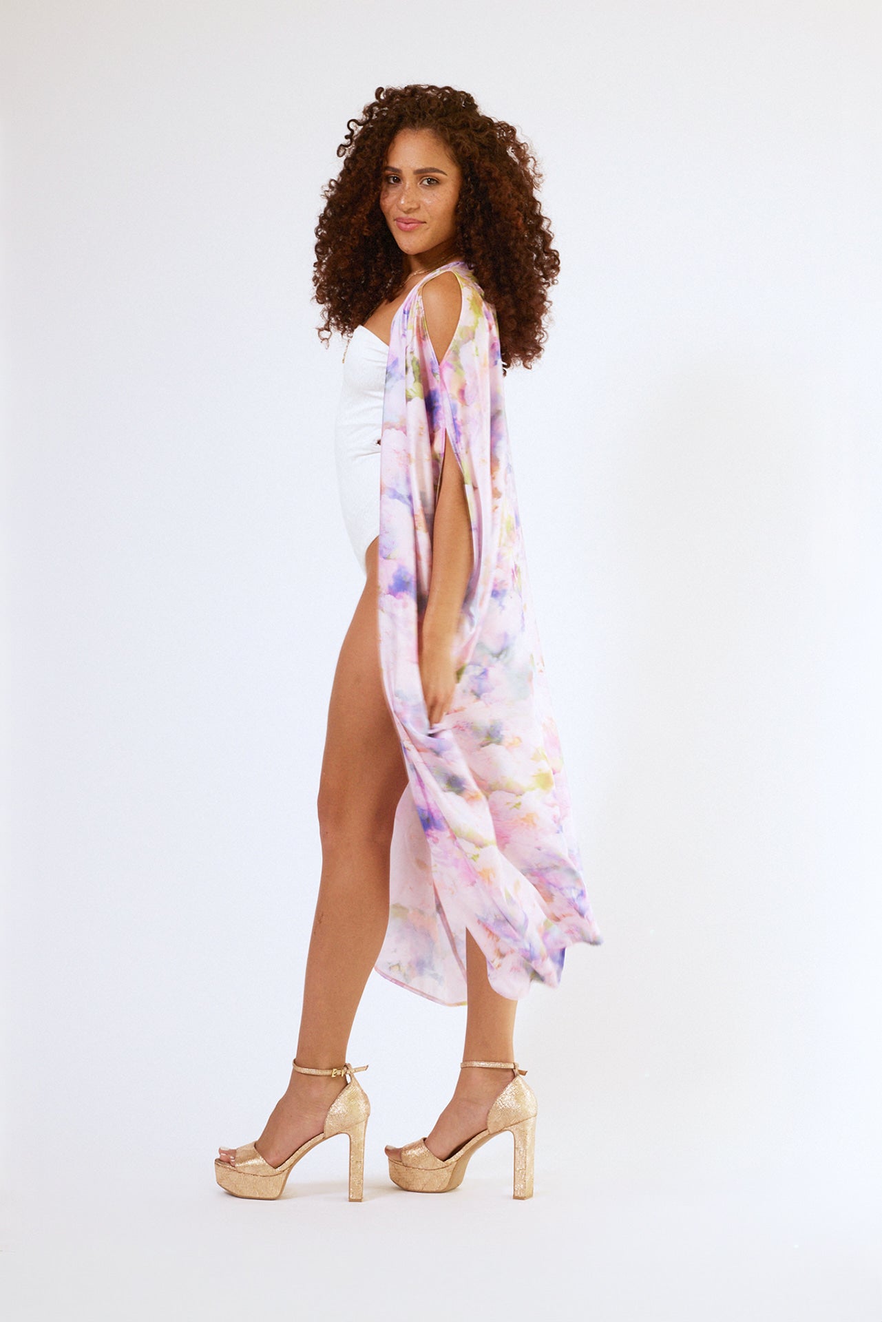 side profile of woman modelling pink floral kaftan duster with front zipper made from recycled textiles 4